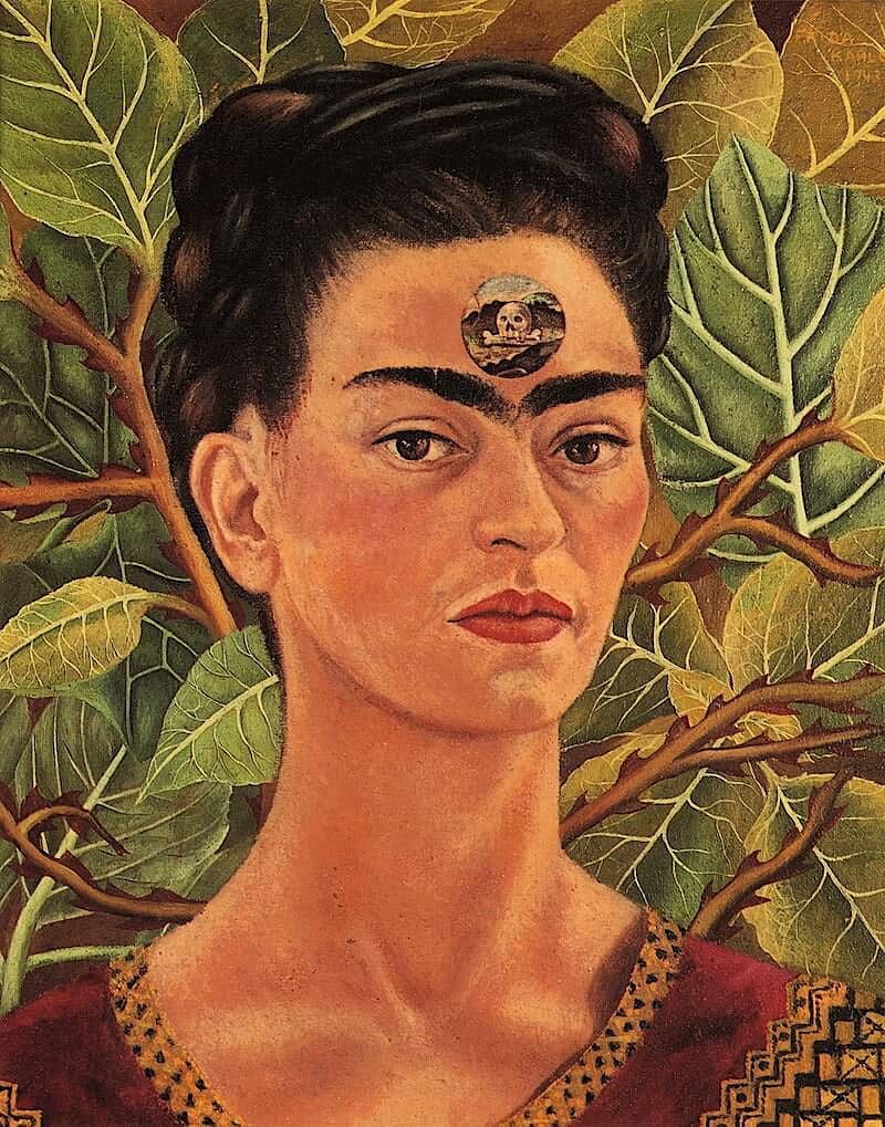 This image is a painting of a woman with a third eye tattooed on her forehead. She is wearing a traditional Mexican costume and there are branches with green leaves in the background. - Frida Kahlo