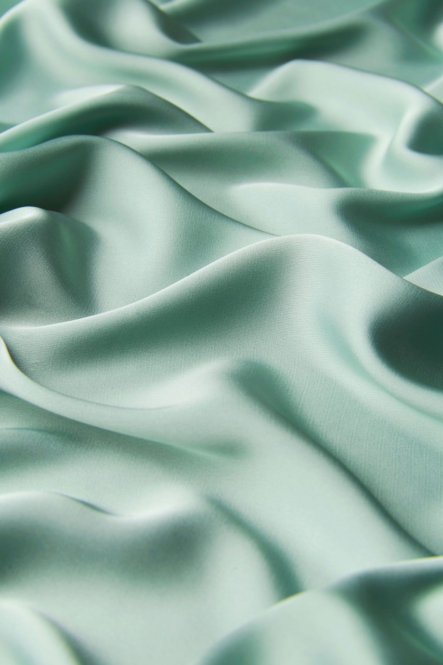 A close up of a green silk fabric - Silk