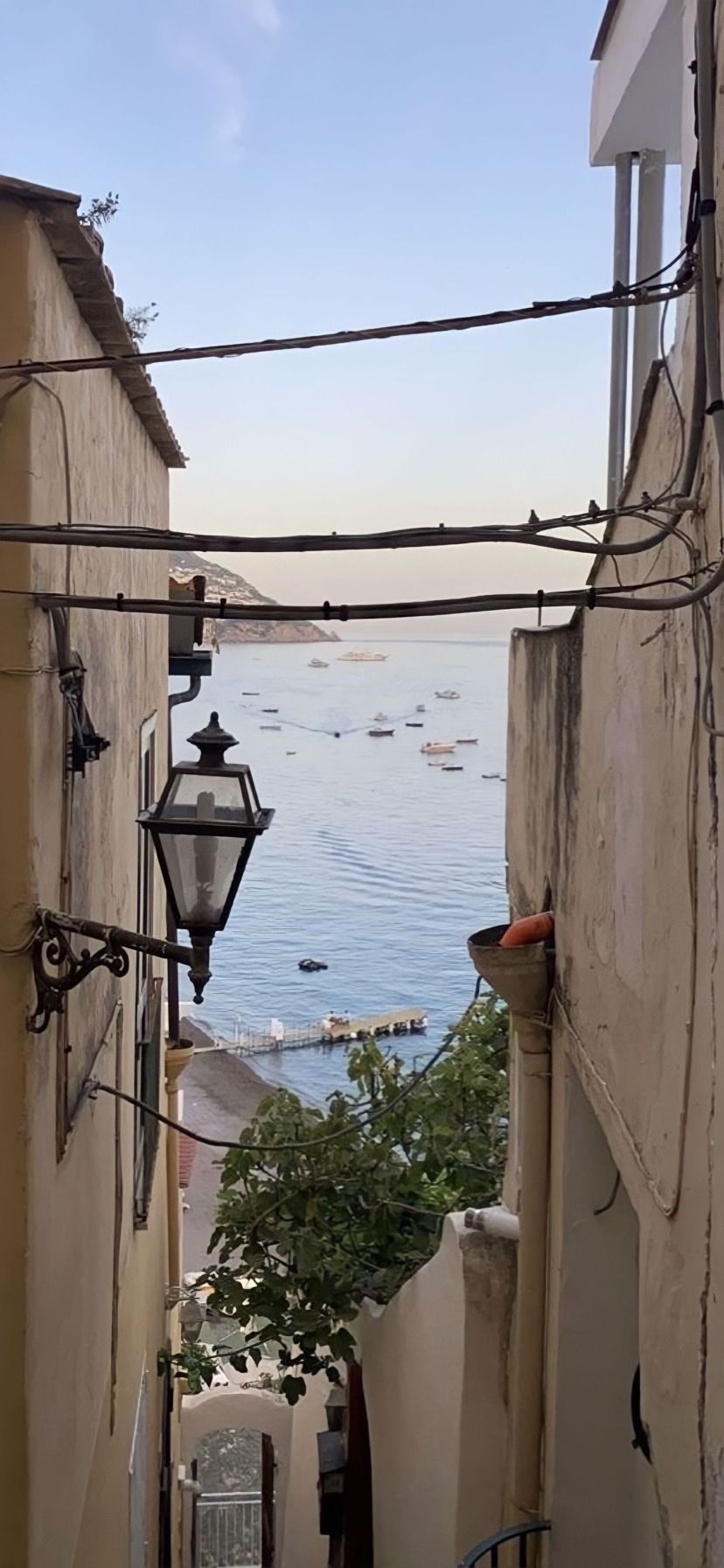 A view of the sea through a narrow alleyway in Positano, Italy - Italy
