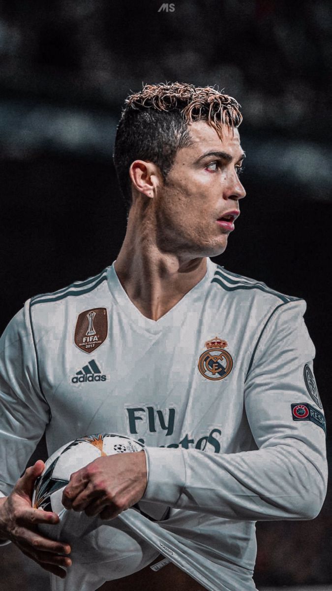 Cristiano Ronaldo holding a soccer ball in his hands - Cristiano Ronaldo