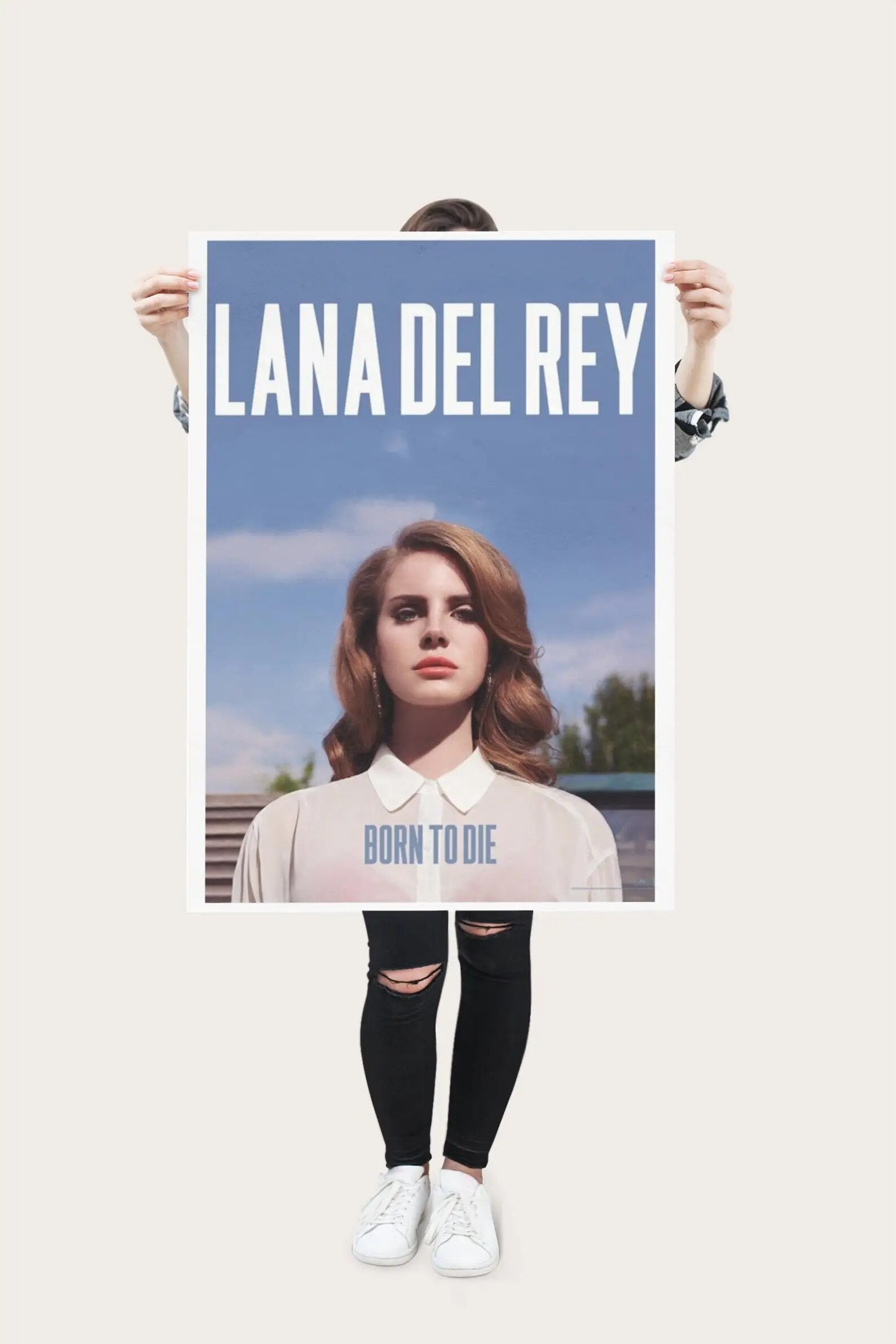 A woman holding a poster of Lana Del Rey's Born to Die album cover - Lana Del Rey