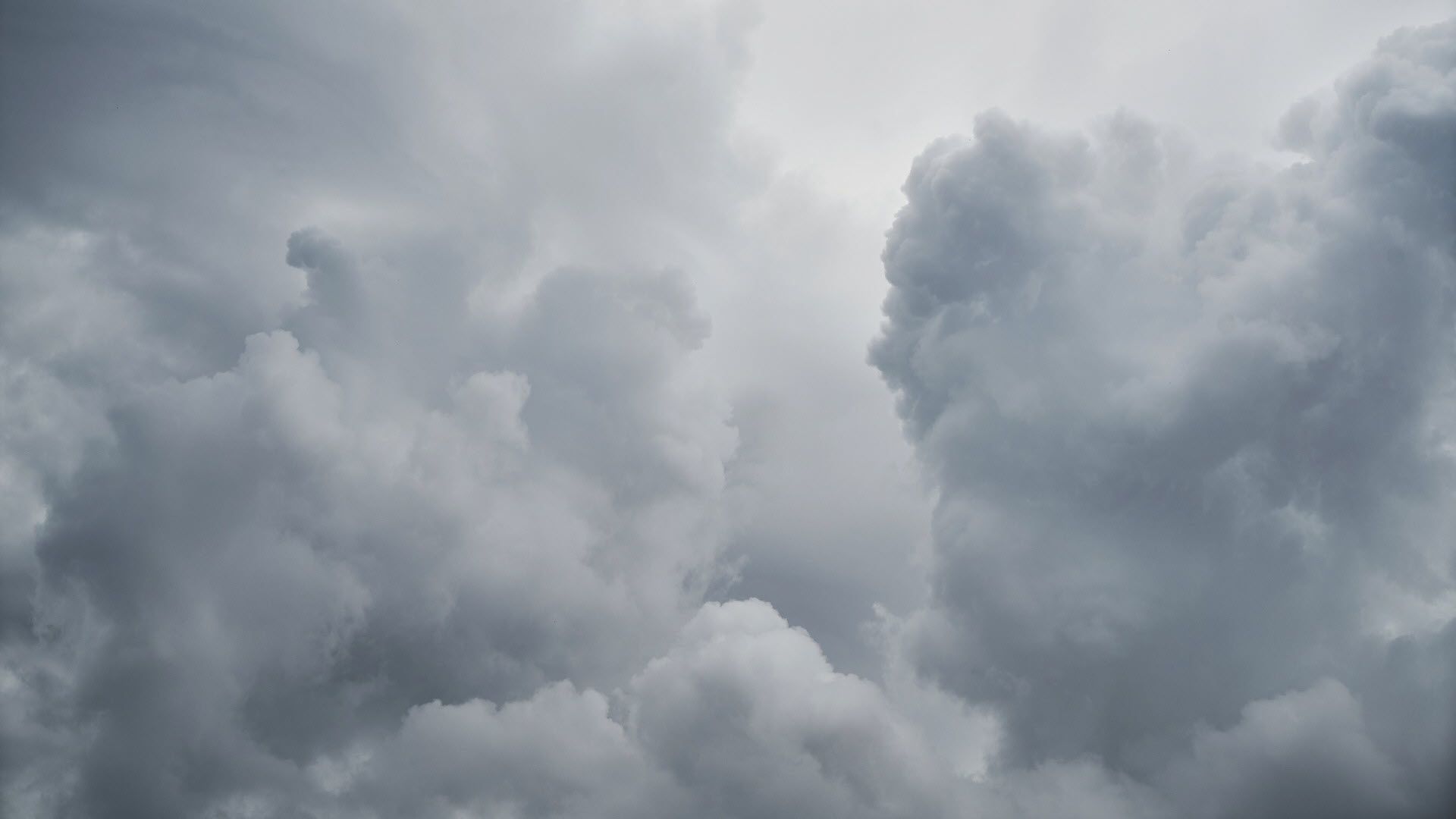 A large white cloud in a grey sky. - Rain