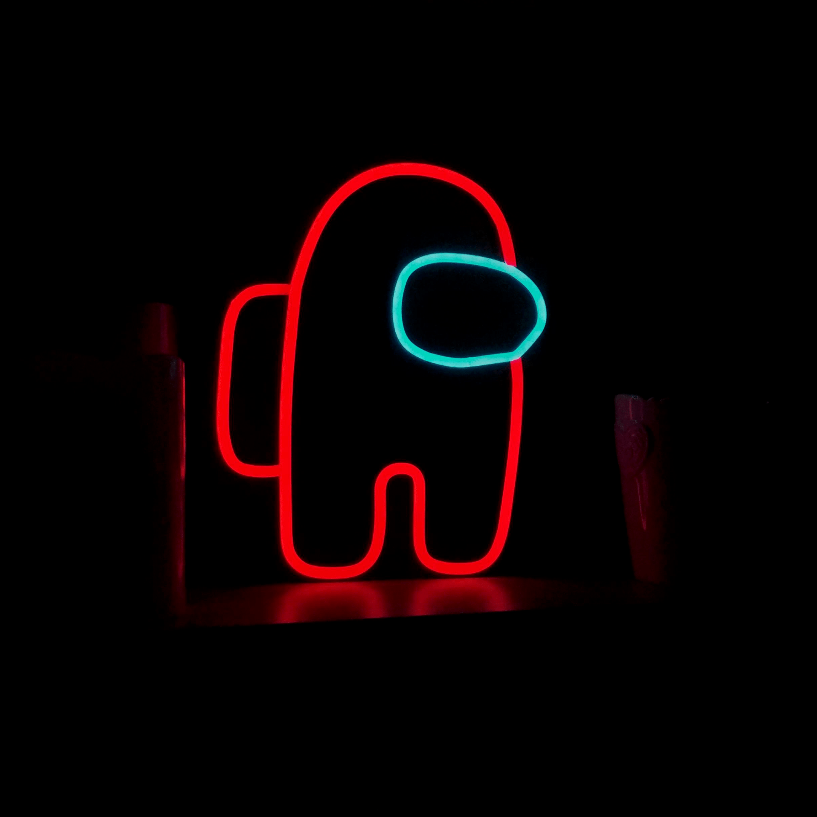 A neon sign with an astronaut on it - Among Us