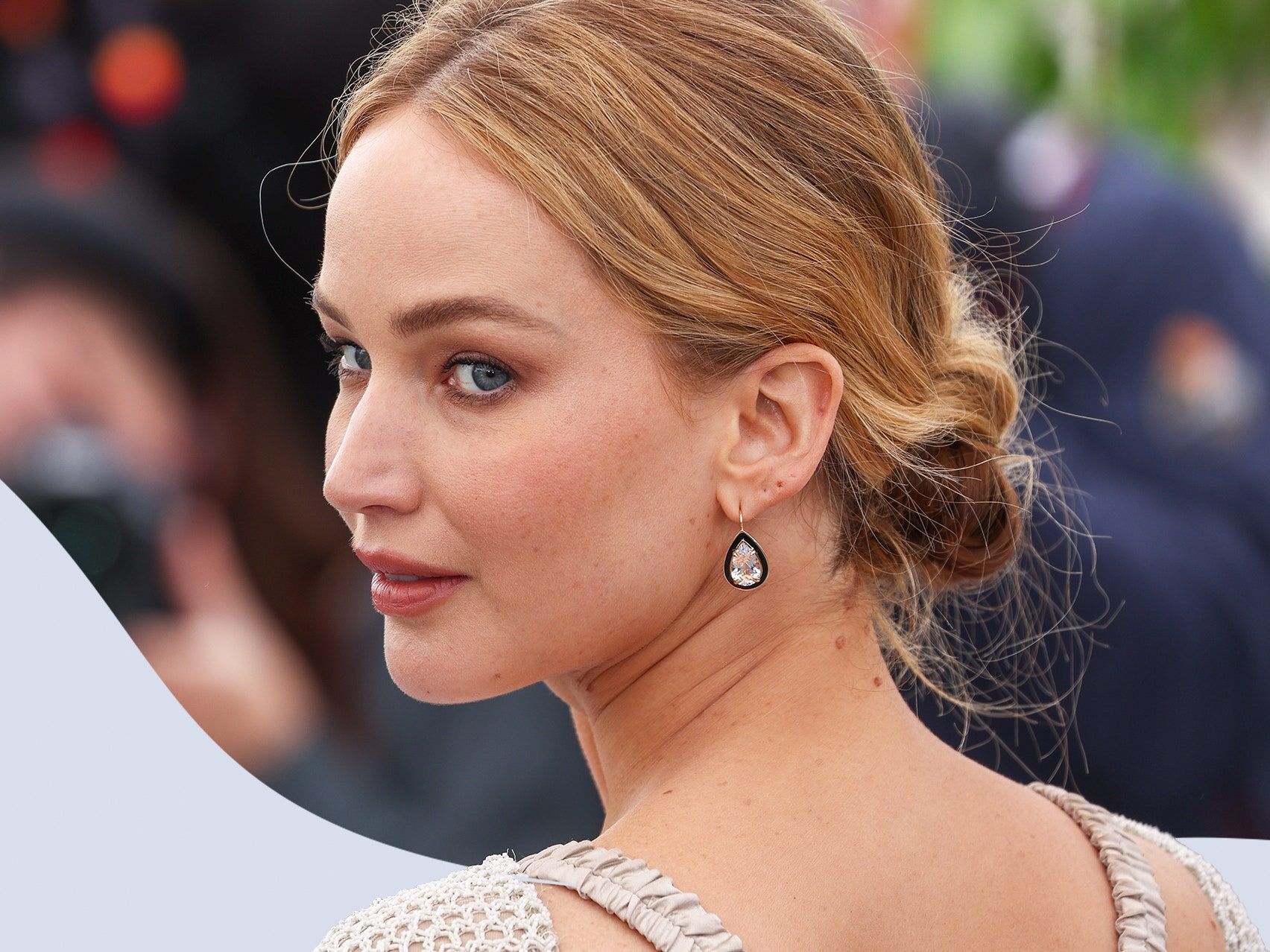 Lily-Rose Depp with her hair in a low bun, wearing diamond earrings - Jennifer Lawrence