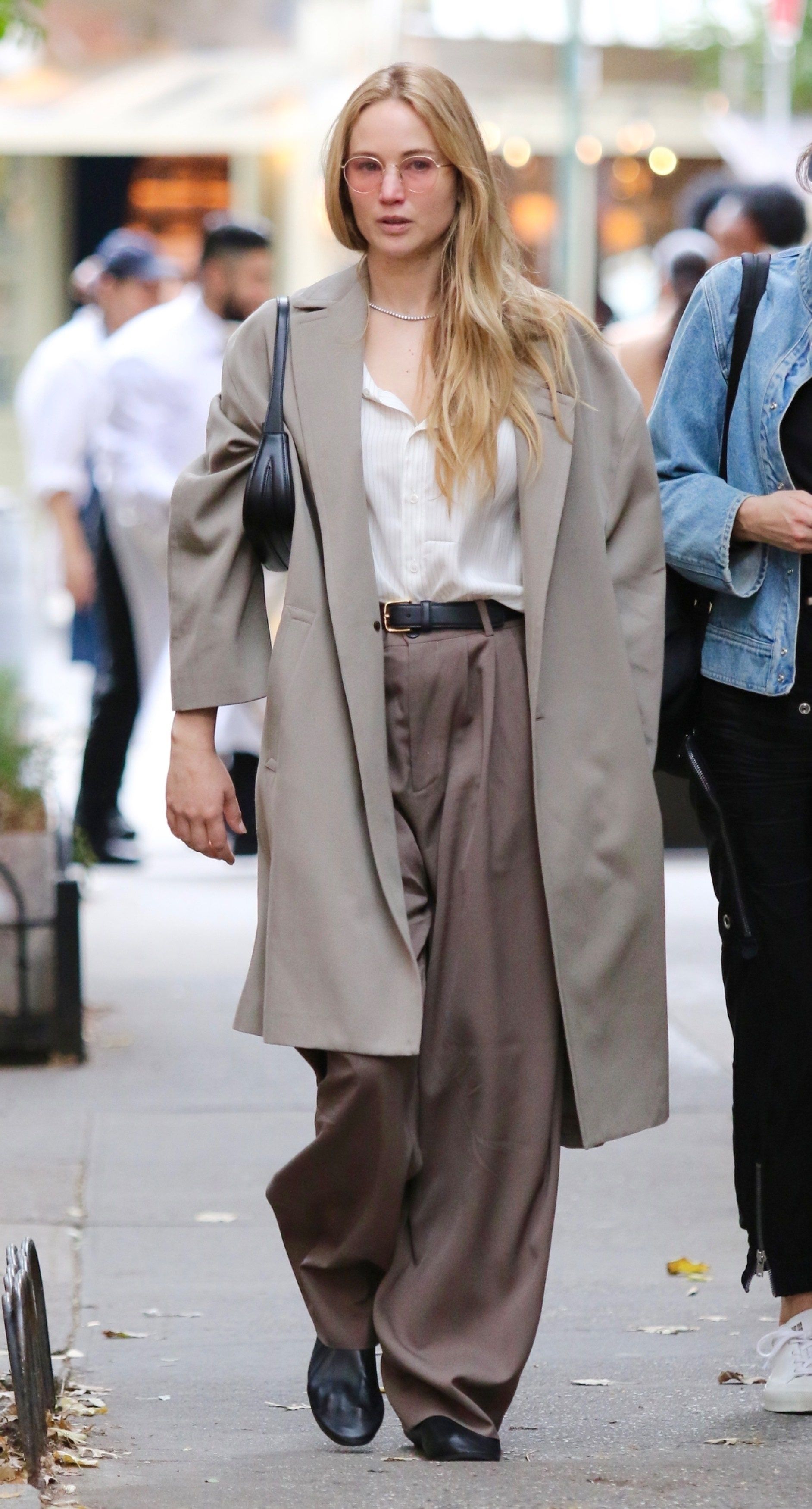 The 24-year-old model wore a pair of wide-leg trousers with a white shirt and a beige coat. - Jennifer Lawrence