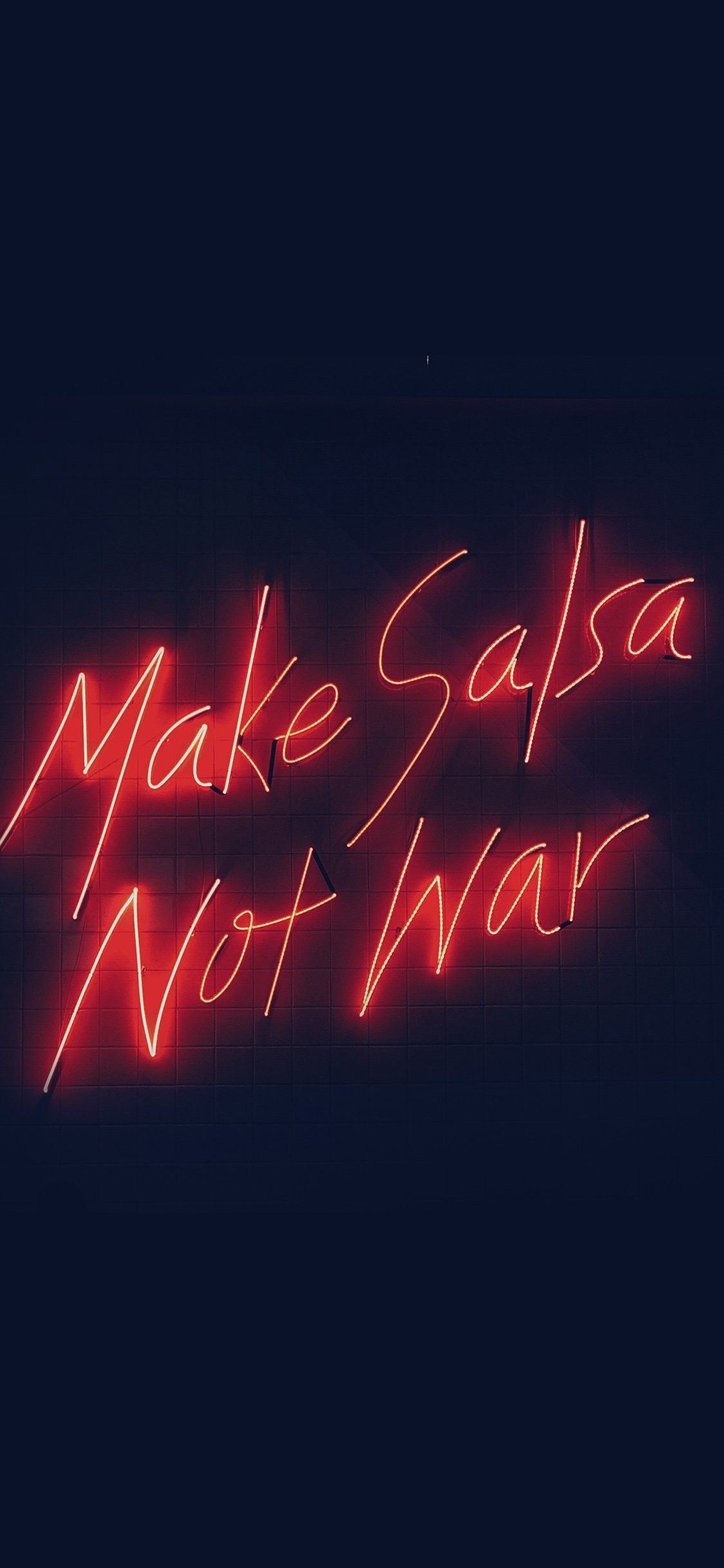 A neon sign that says make salsa not war - Neon red