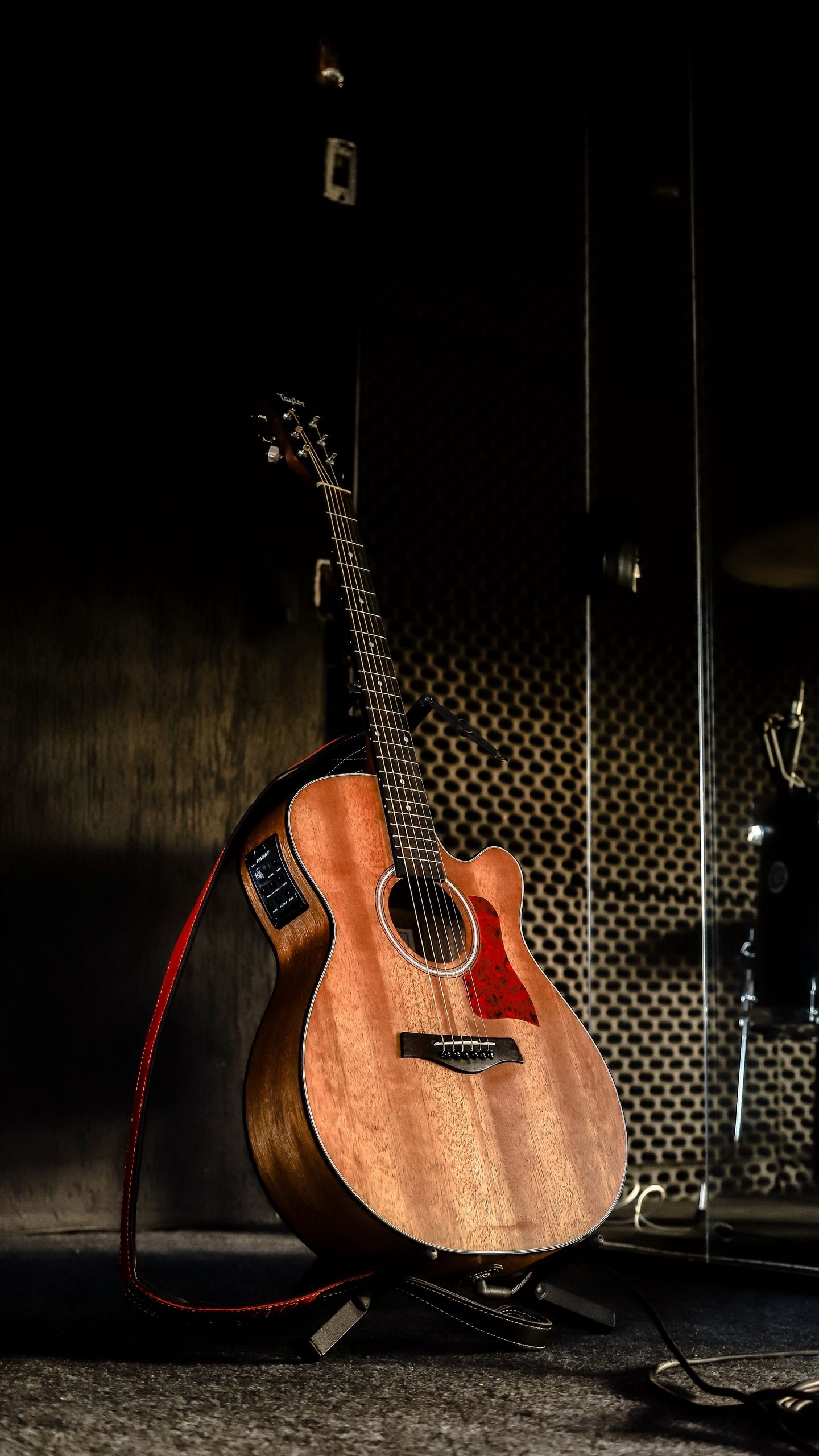 A Taylor acoustic guitar in a dark room. - Guitar