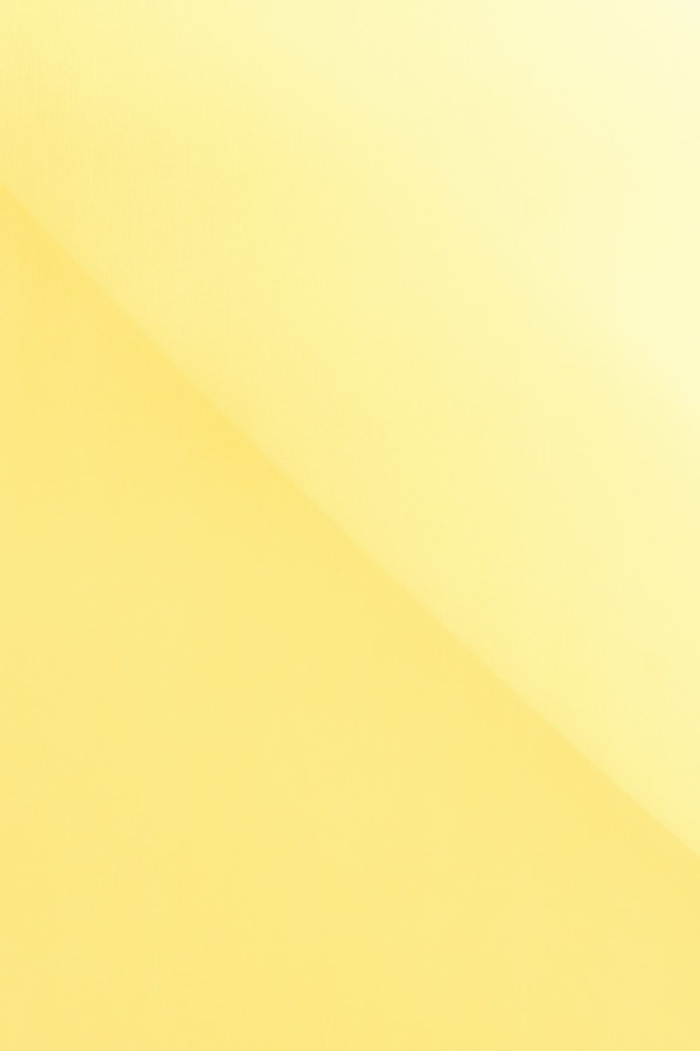 A yellow background with an apple on it - Light yellow