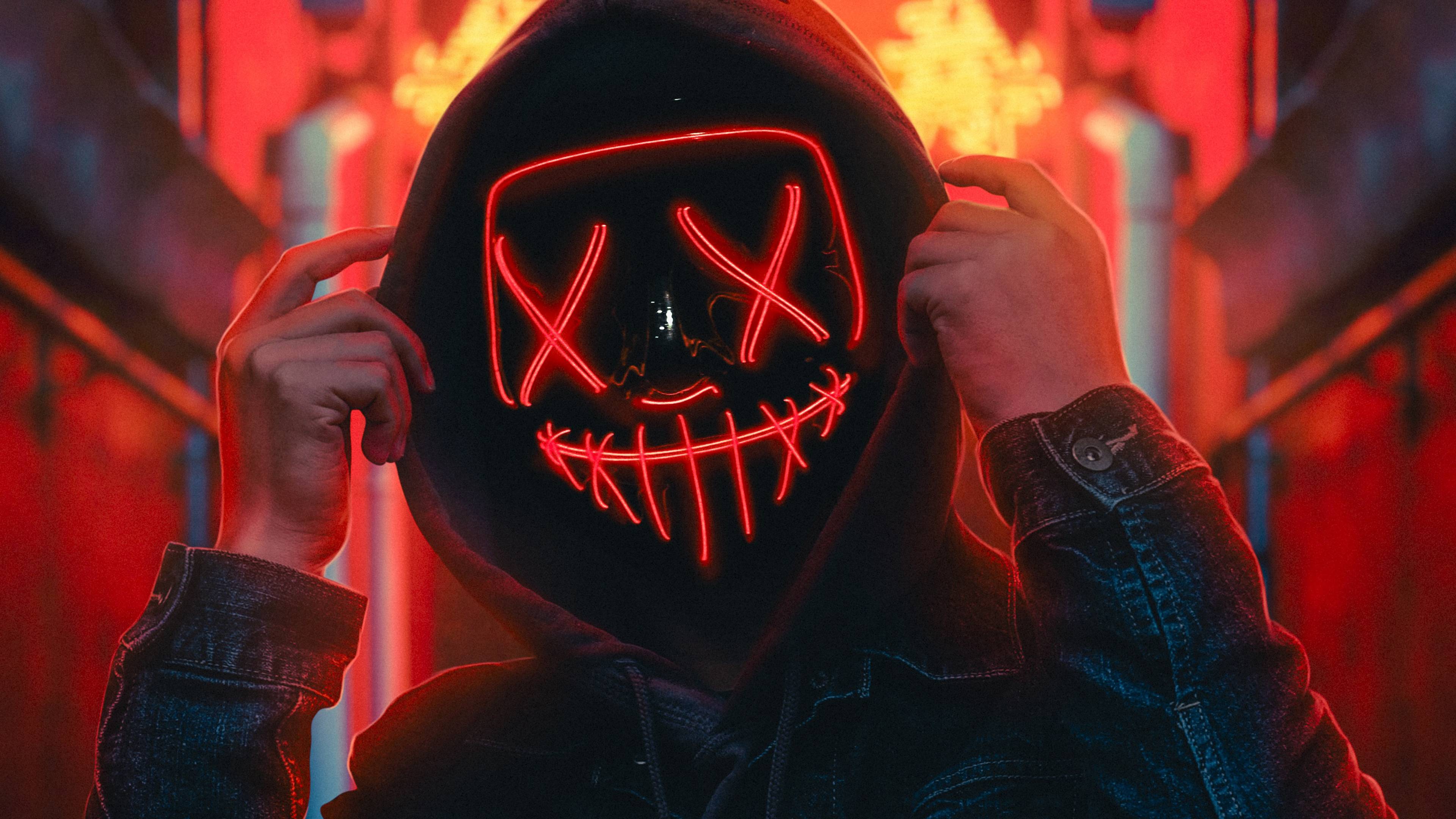 A person wearing an illuminated mask - Neon red, light red