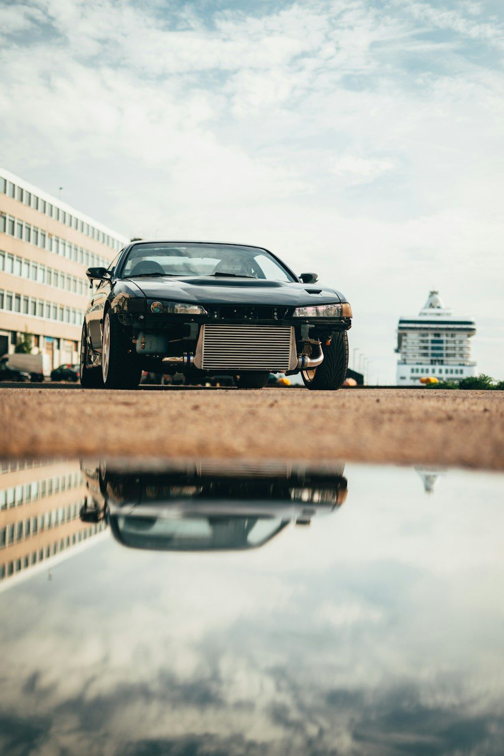 A black car parked on the side of the road - JDM