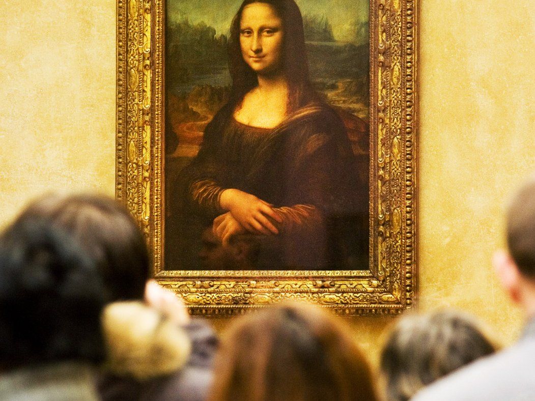 A crowd of people looking at the Mona Lisa painting. - Mona Lisa