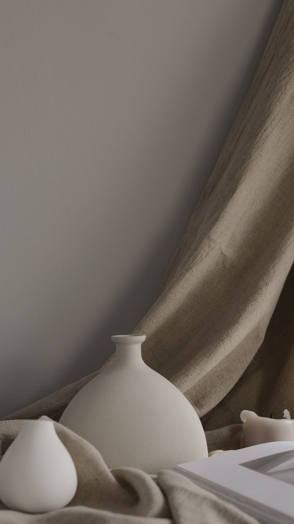 A vase sitting on top of some fabric - Minimalist beige, neutral