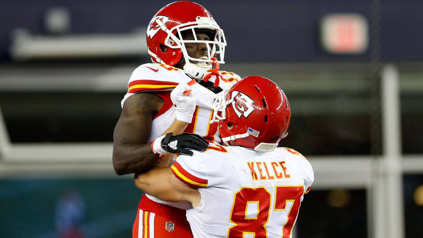Travis Kelce is hugged by a teammate after catching a touchdown pass. - Travis Kelce