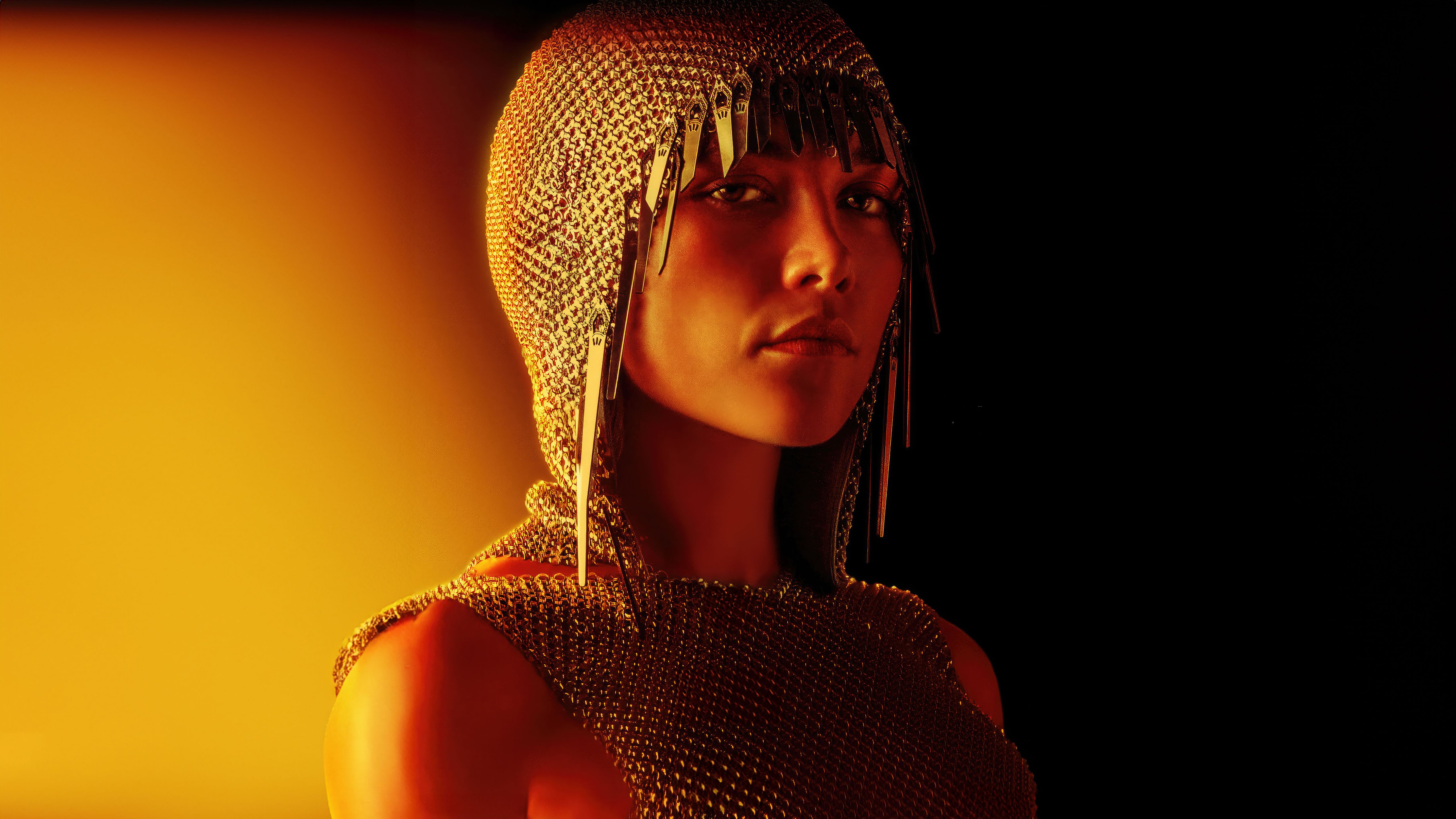 A woman with a chainmail hood on. - Florence Pugh