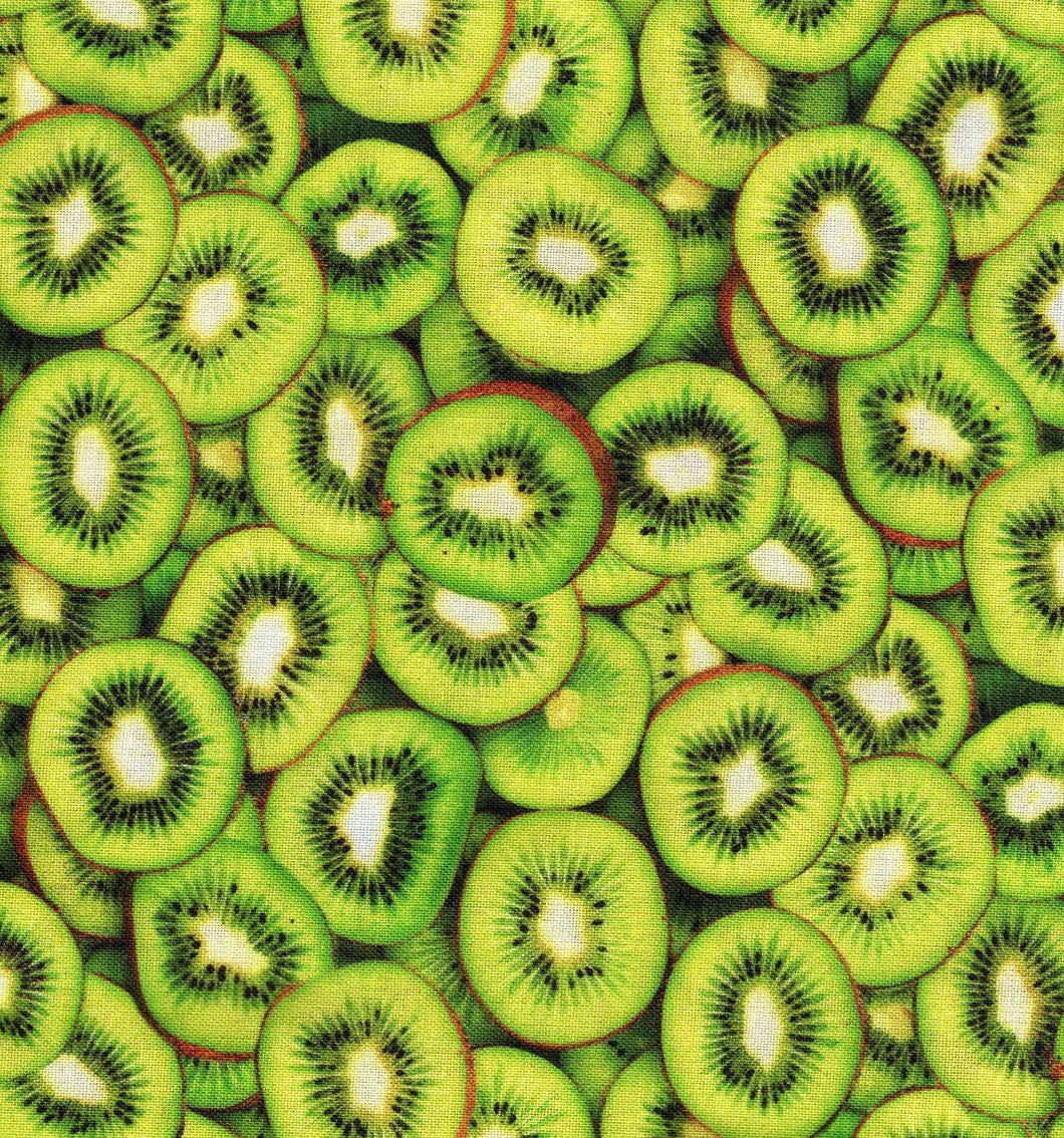 Fabric with slices of kiwi fruit on a green background - Kiwi