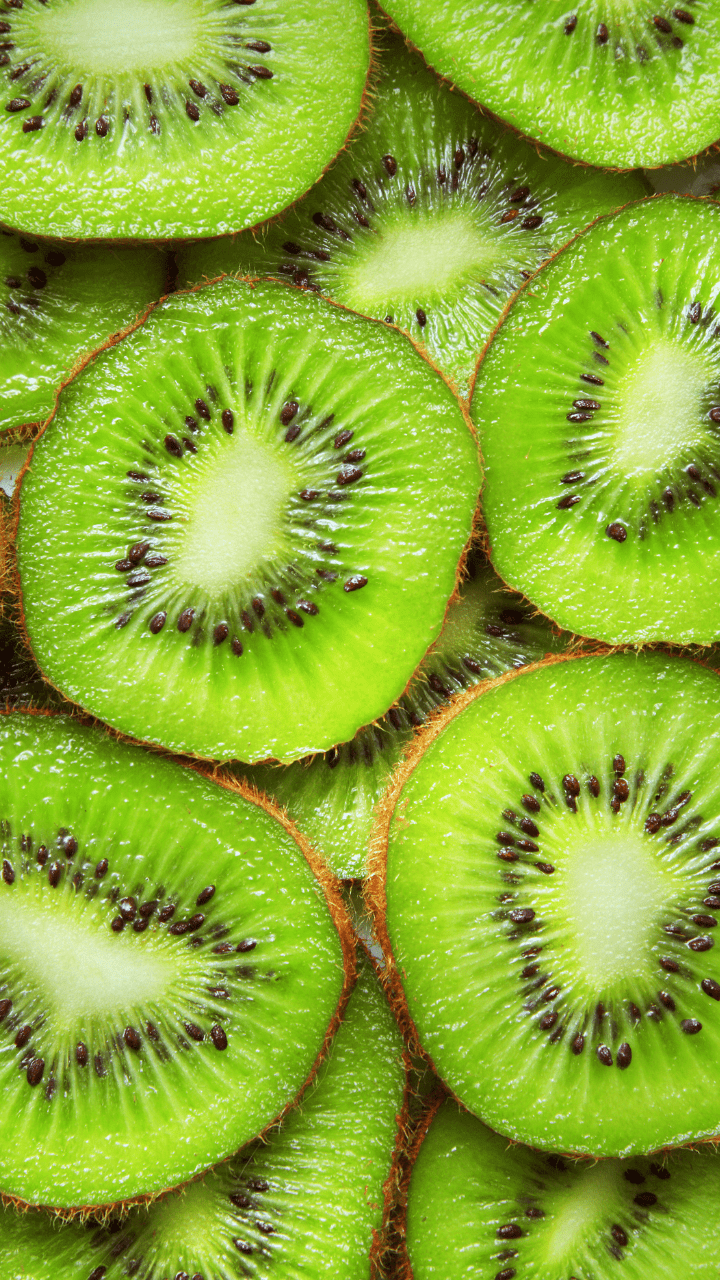 A close up of sliced kiwi fruit. - Kiwi
