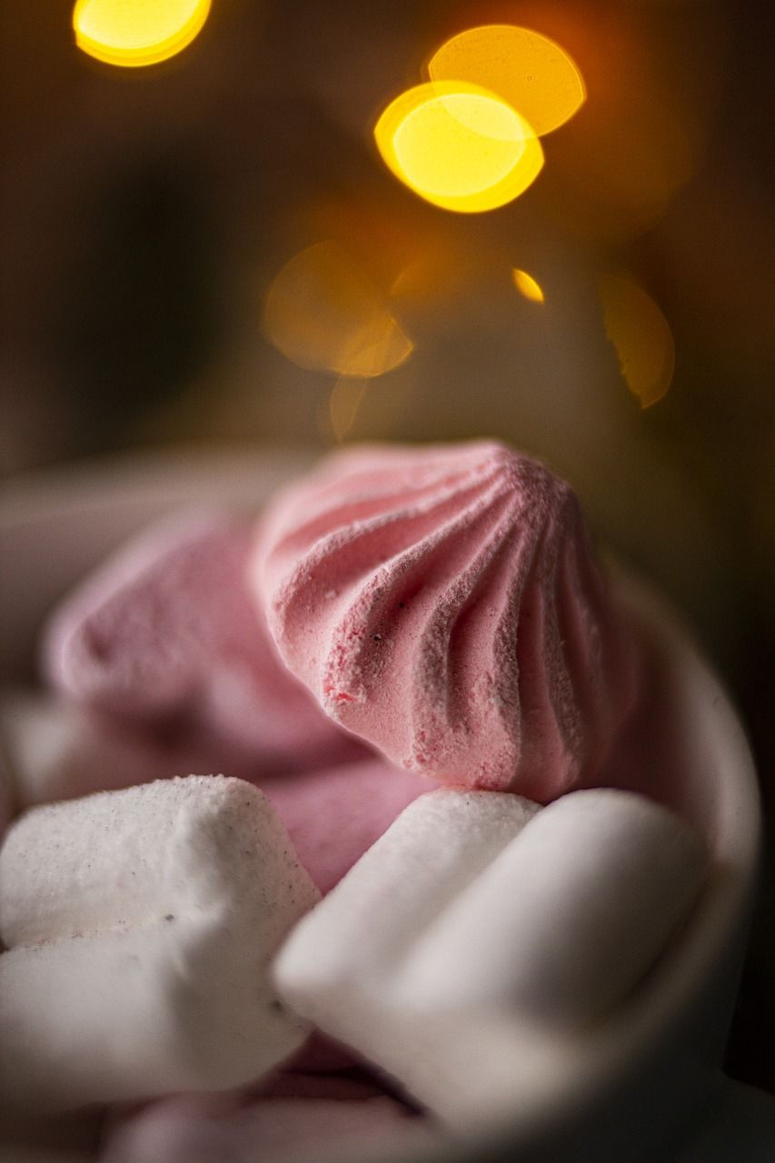 Pink and white meringue cookies on a plate - Marshmallows