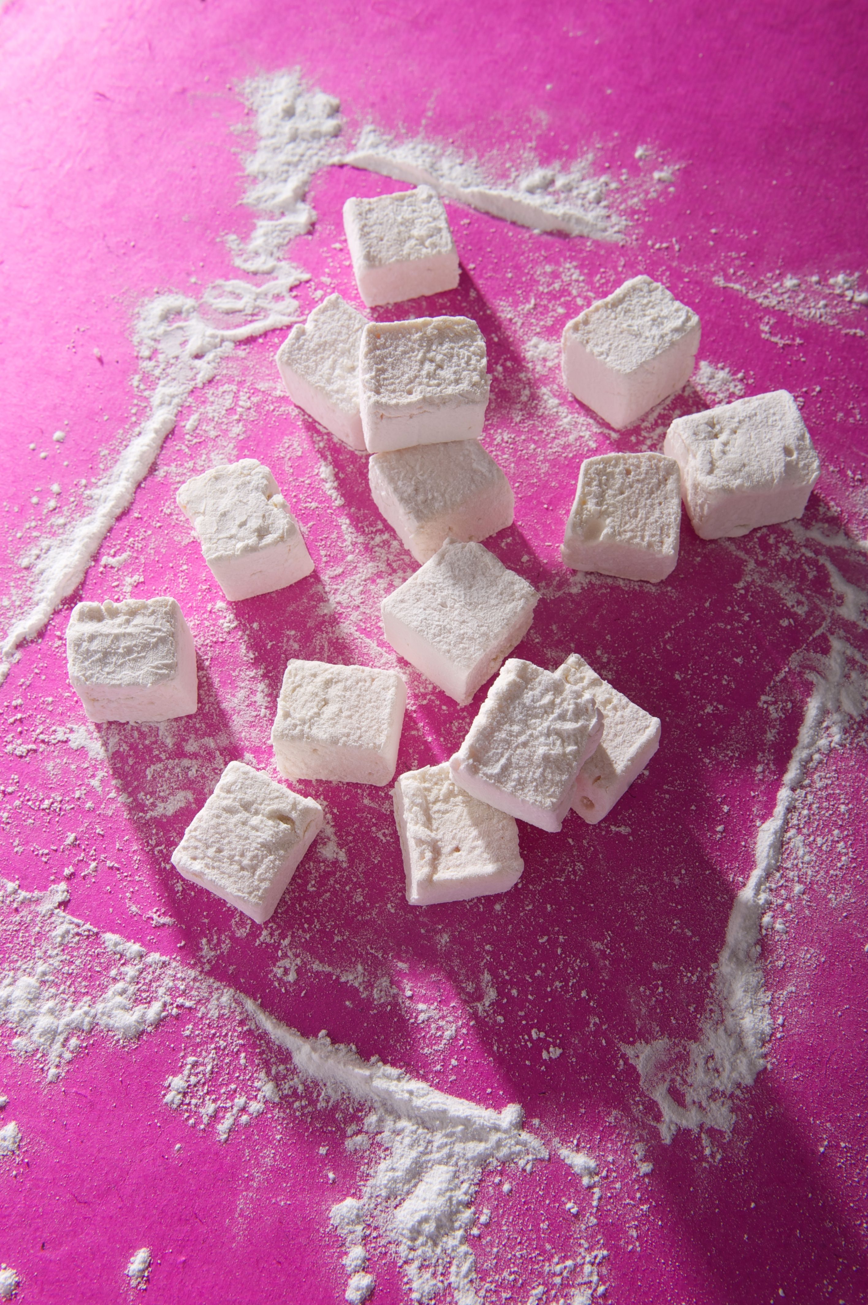 White marshmallows on a pink surface - Marshmallows