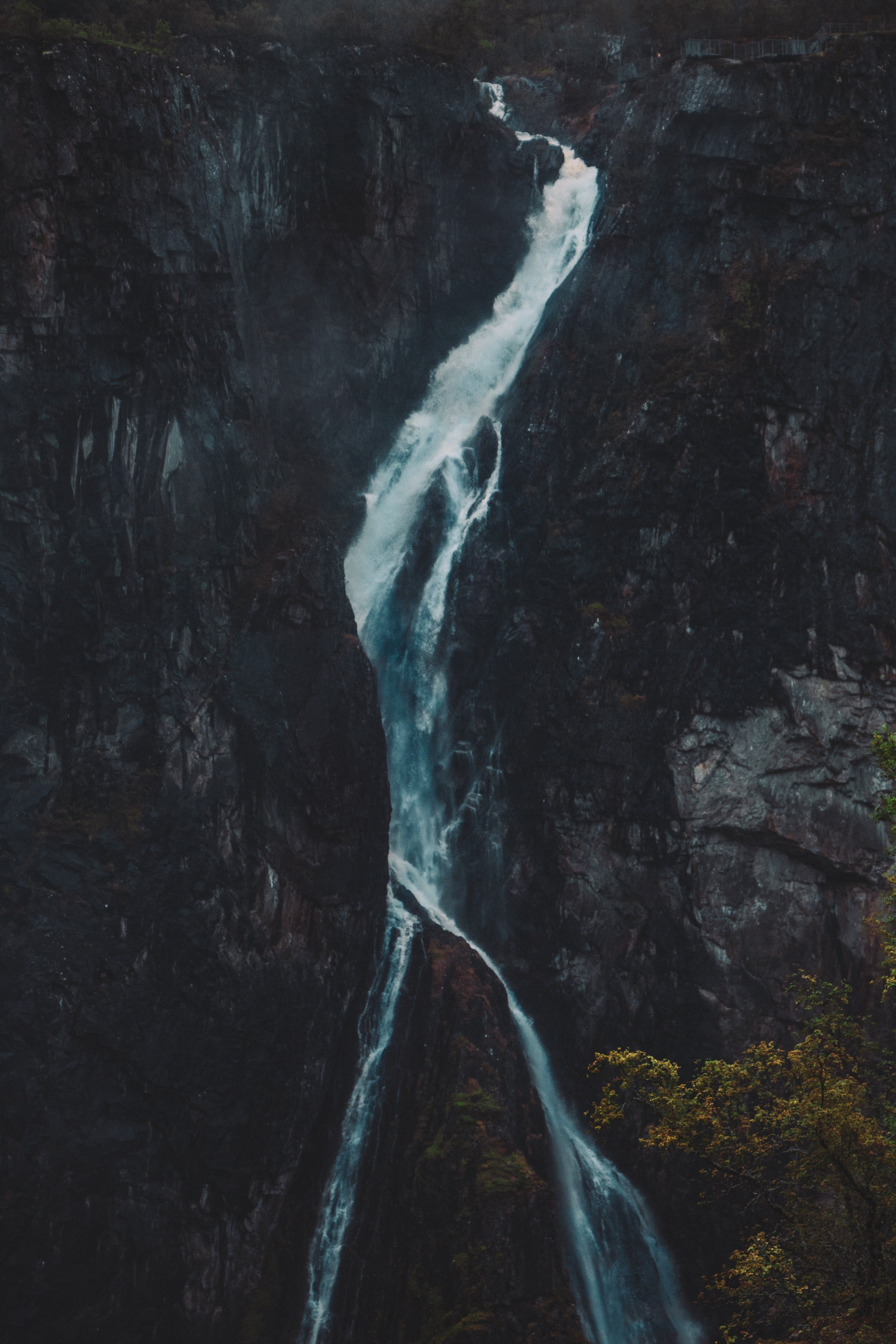 A waterfall cascading down a dark cliffside - Waterfall