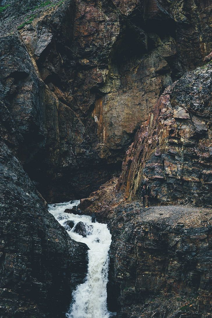 A waterfall surrounded by rocks - Waterfall