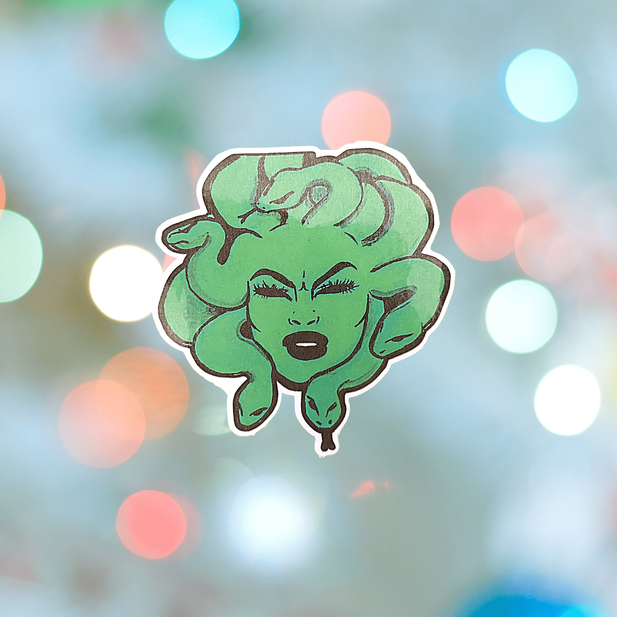 A sticker of Medusa with a blue and green gradient background - Medusa