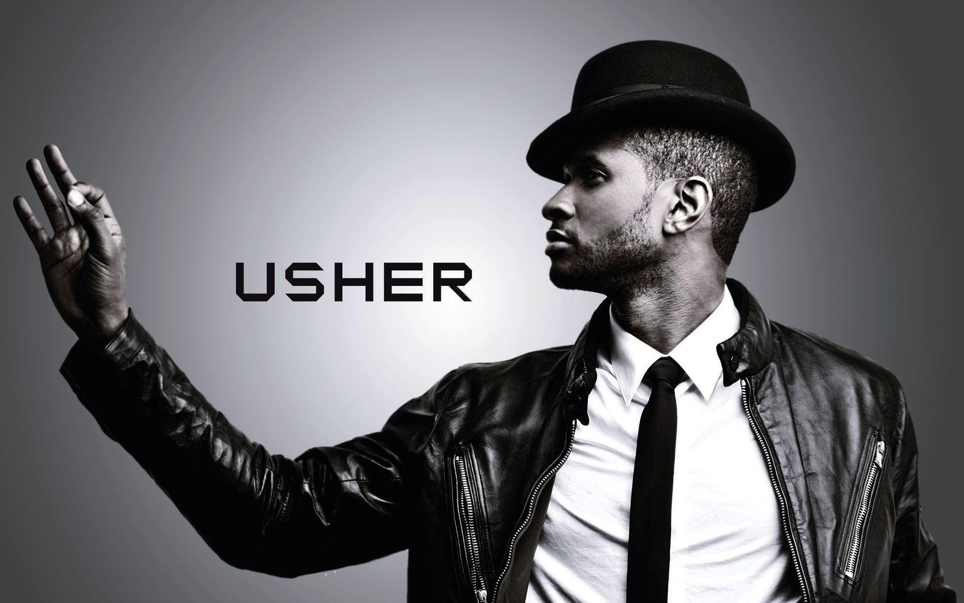 Usher wearing a leather jacket and a hat - Usher