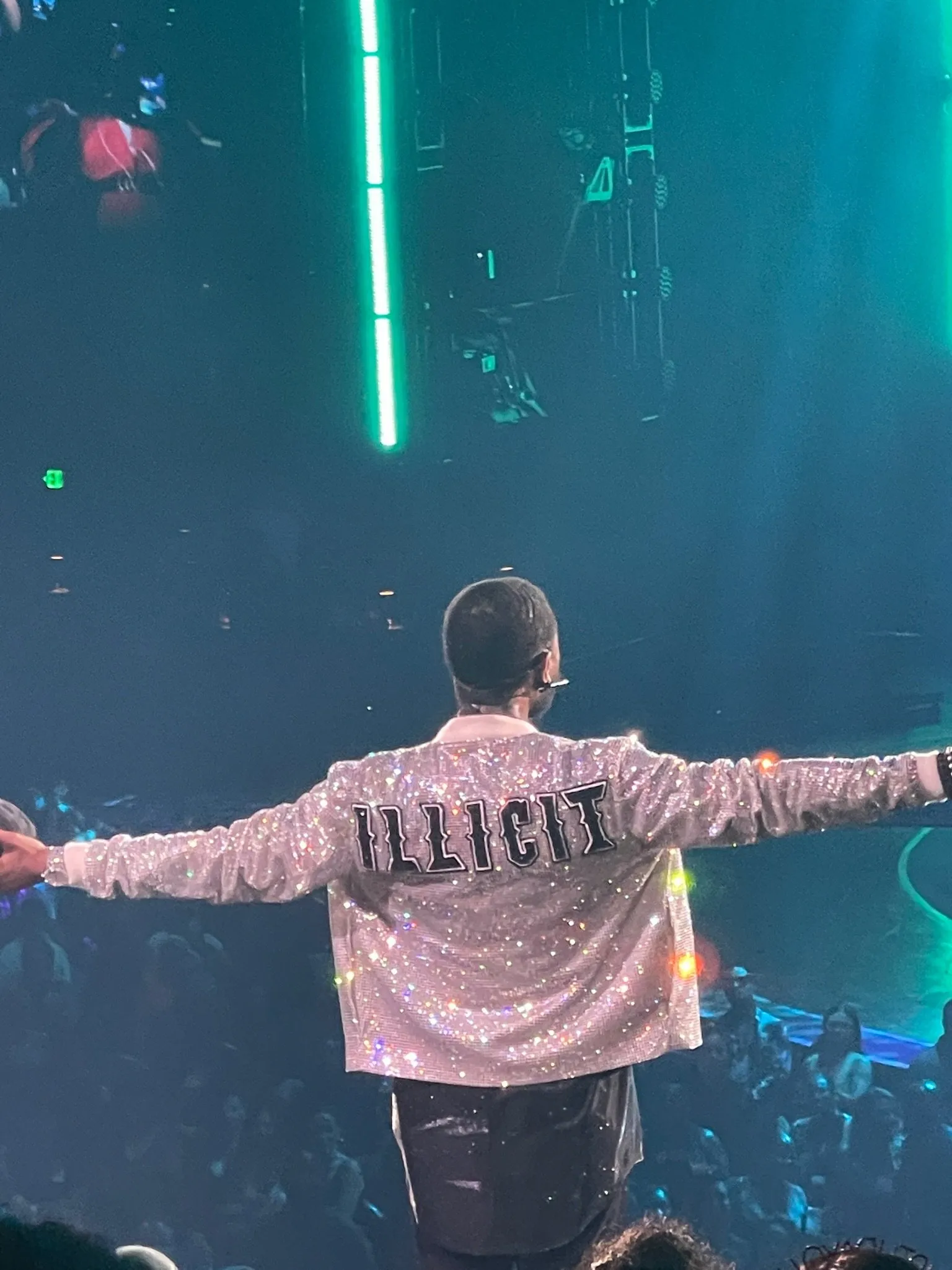 Justin Bieber performing in front of a crowd at a concert. - Usher