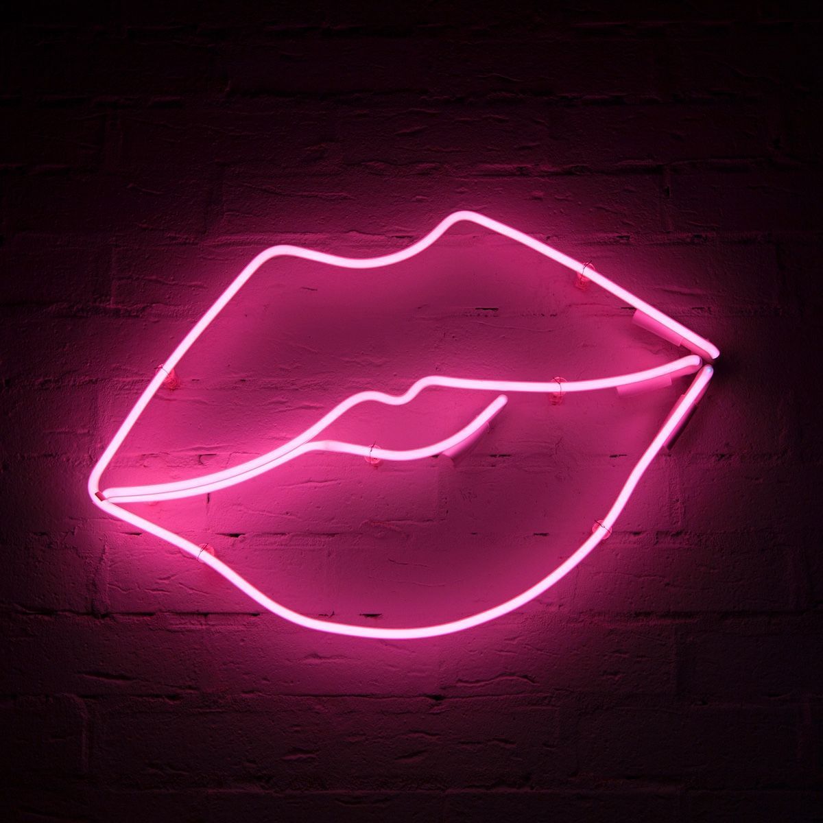 A neon pink sign with lips on it - Hot pink, neon pink