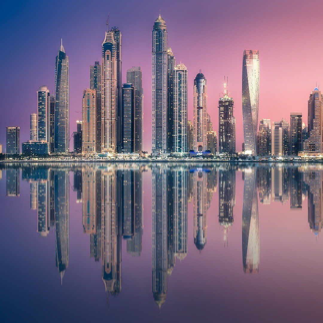 A city skyline with skyscrapers and a body of water - Dubai