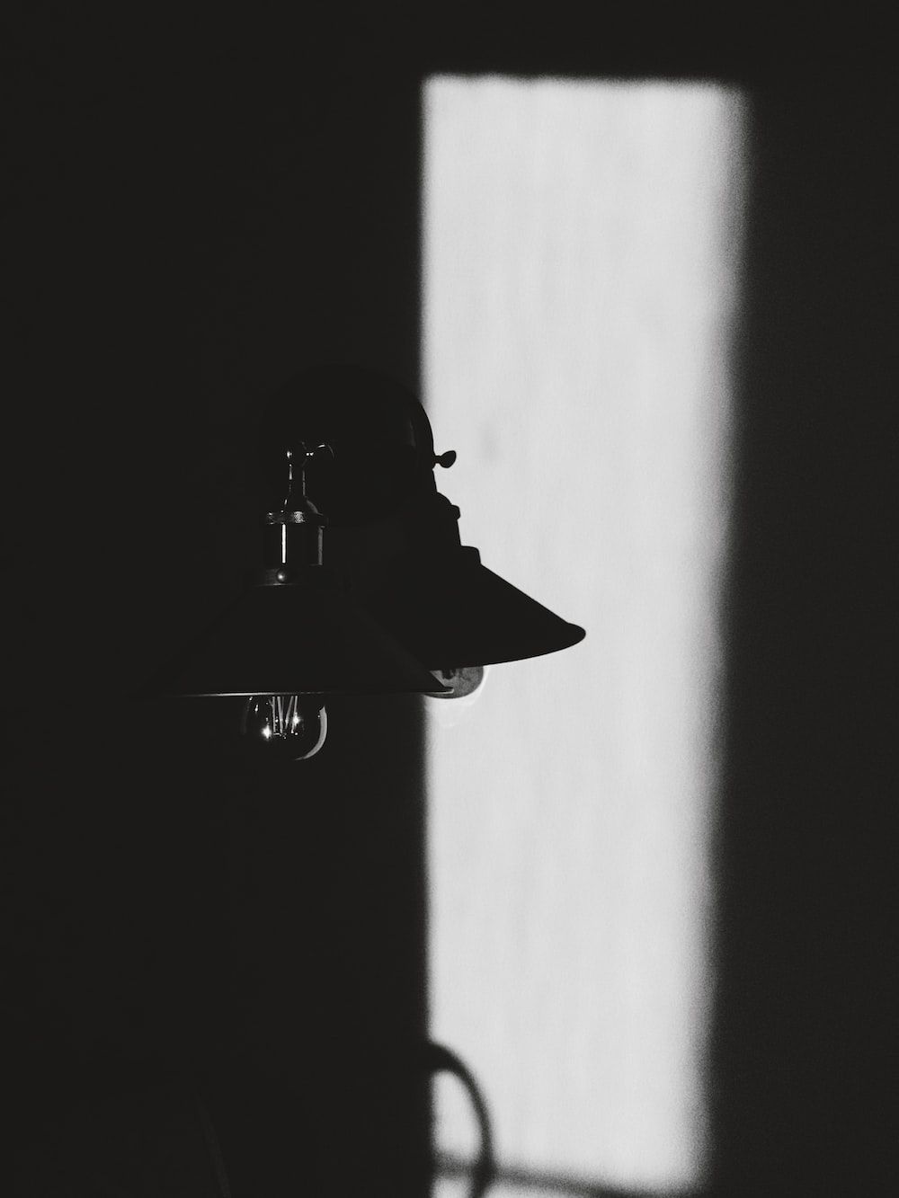 A lamp is sitting on the wall - Black and white