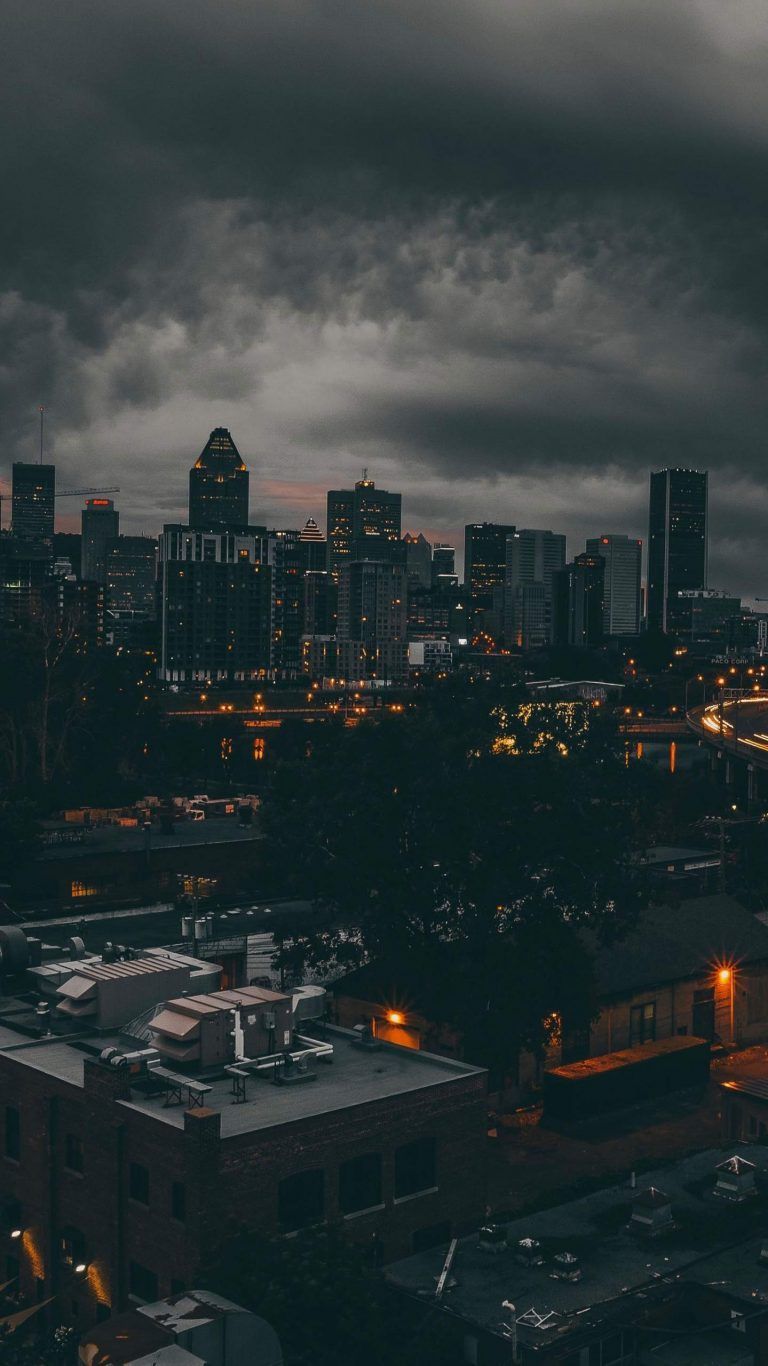 A city skyline at night with storm clouds - City, cityscape, skyline
