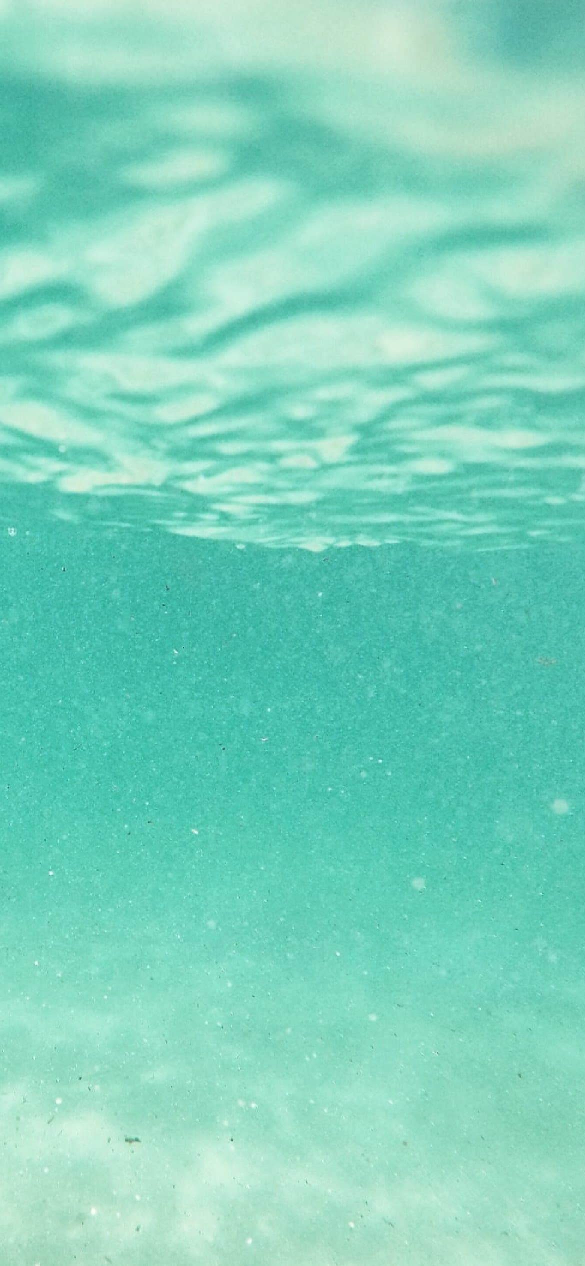 A close up of the water in a swimming pool - Light blue