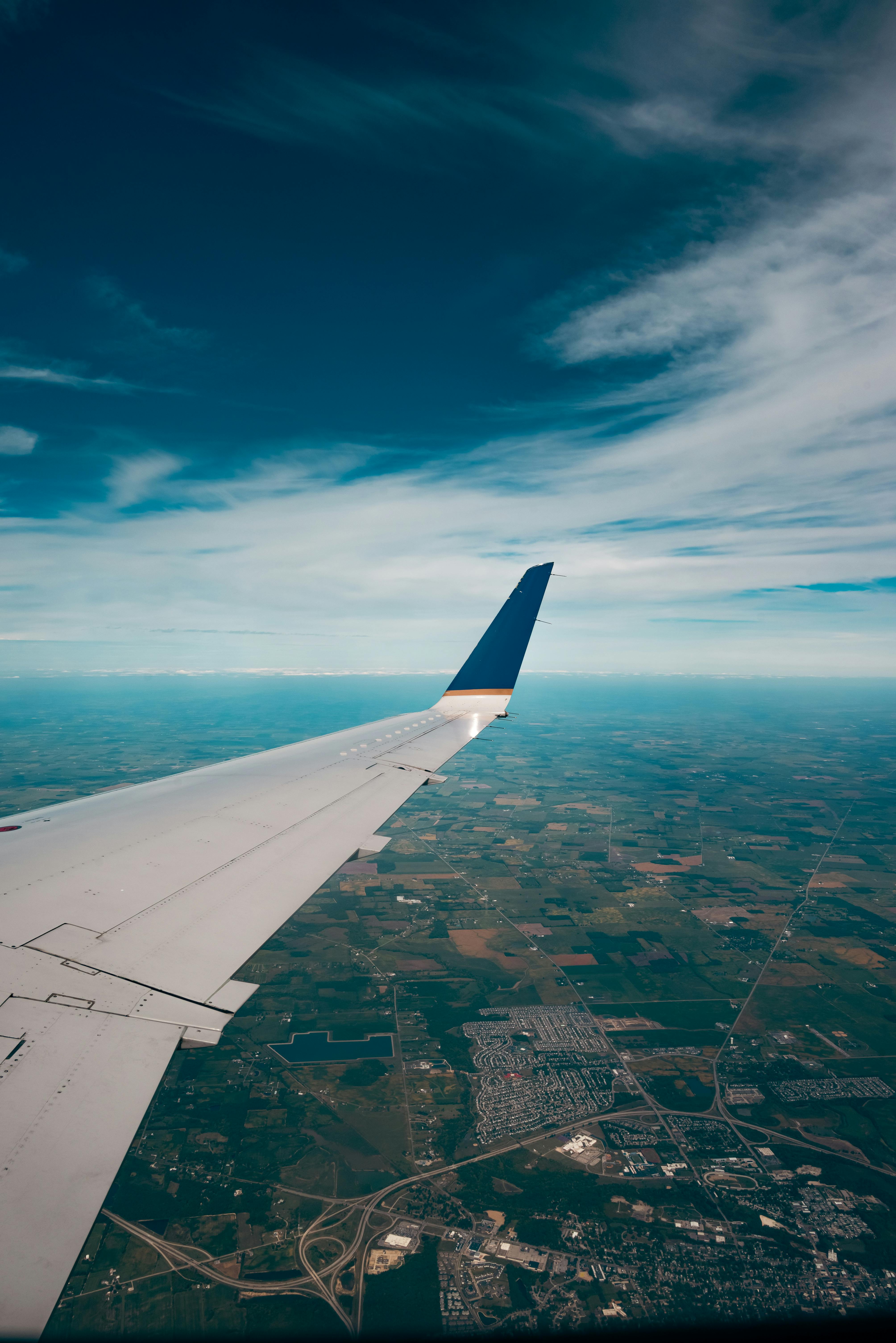 Wing of Airplane Flying over Plains