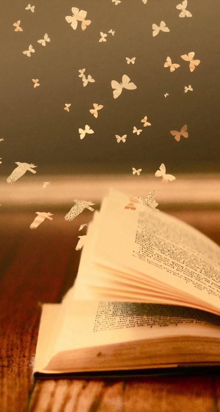 An open book with butterflies flying out of it - Books