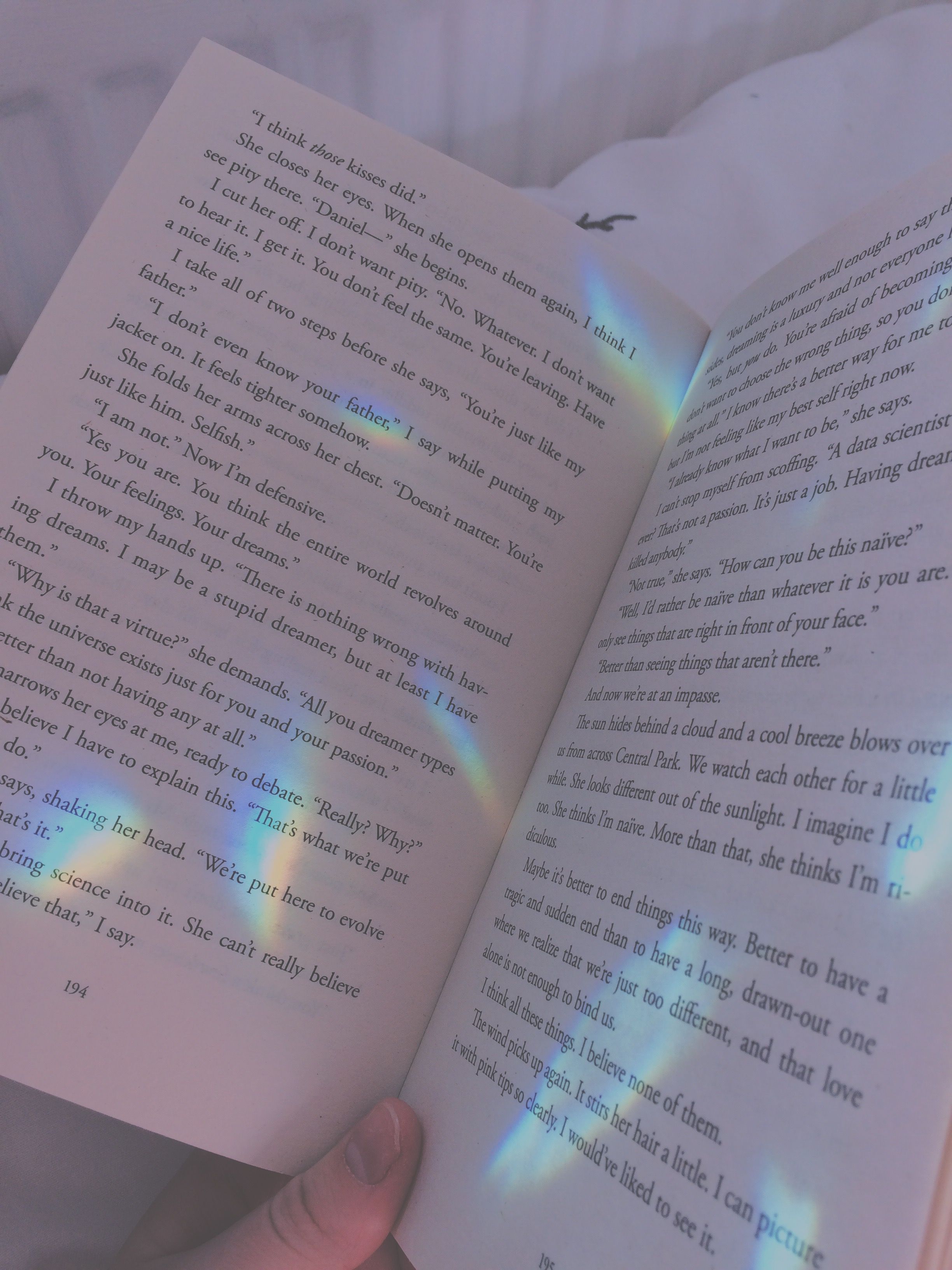 A book with a rainbow light shining on it - Books