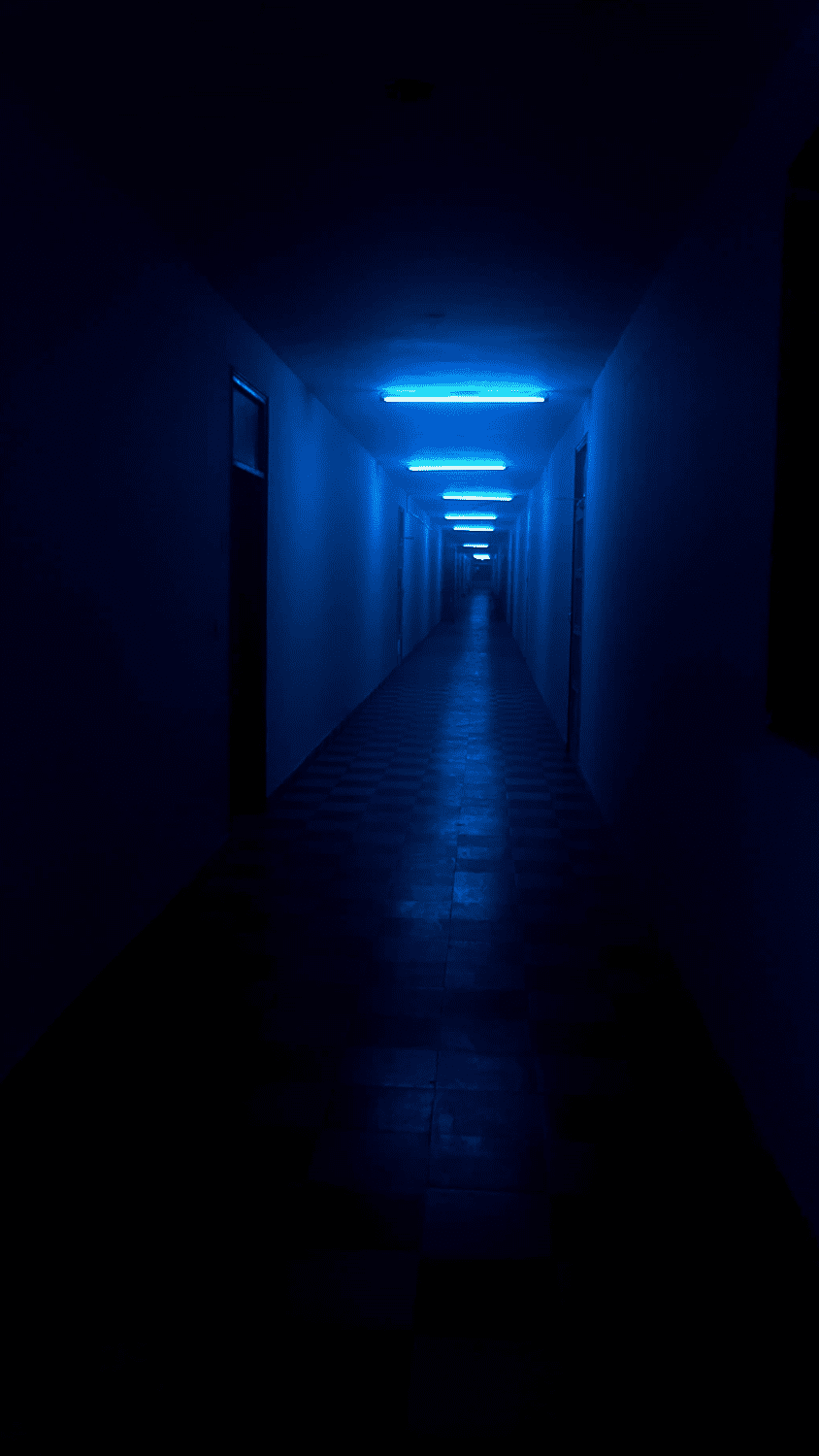 A dark, empty hallway with blue lights at the end. - Dark blue