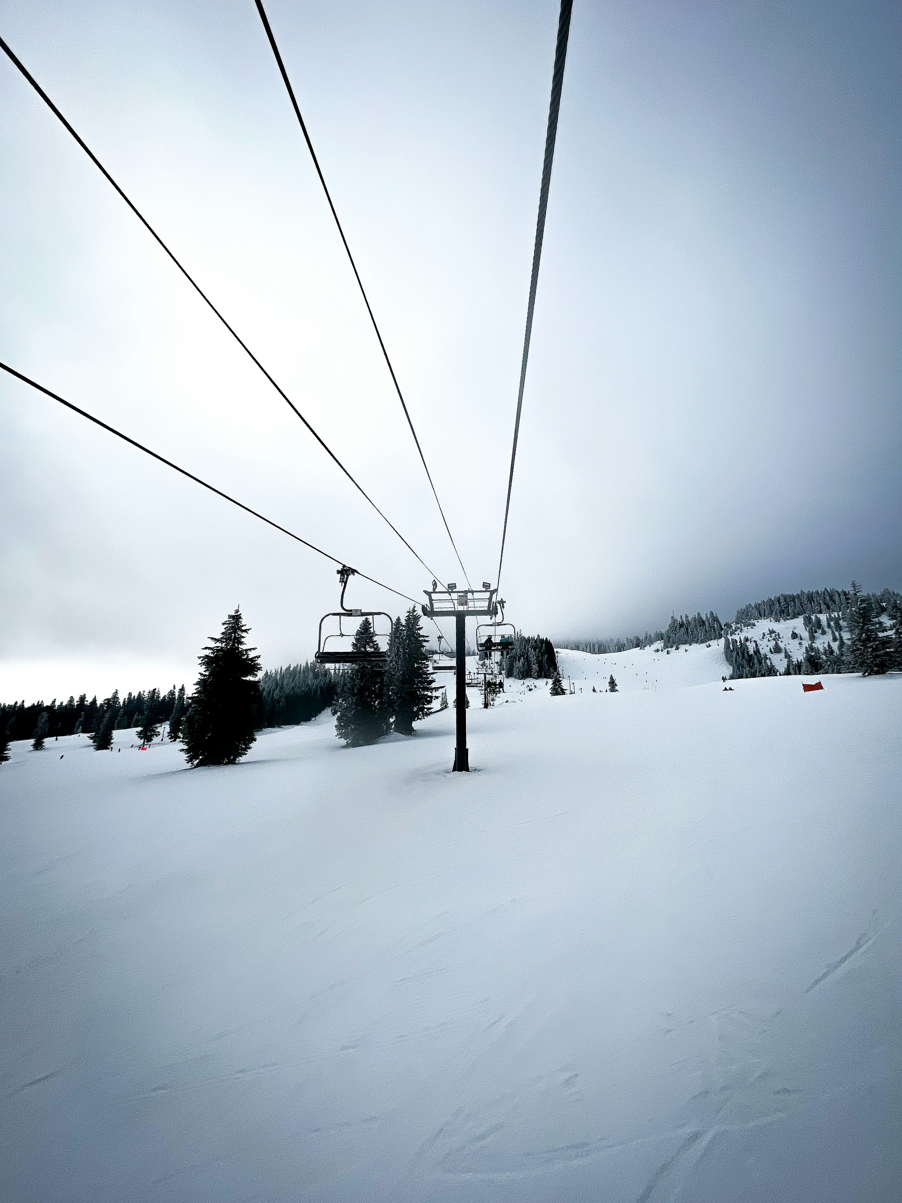 A ski lift going over a snow covered