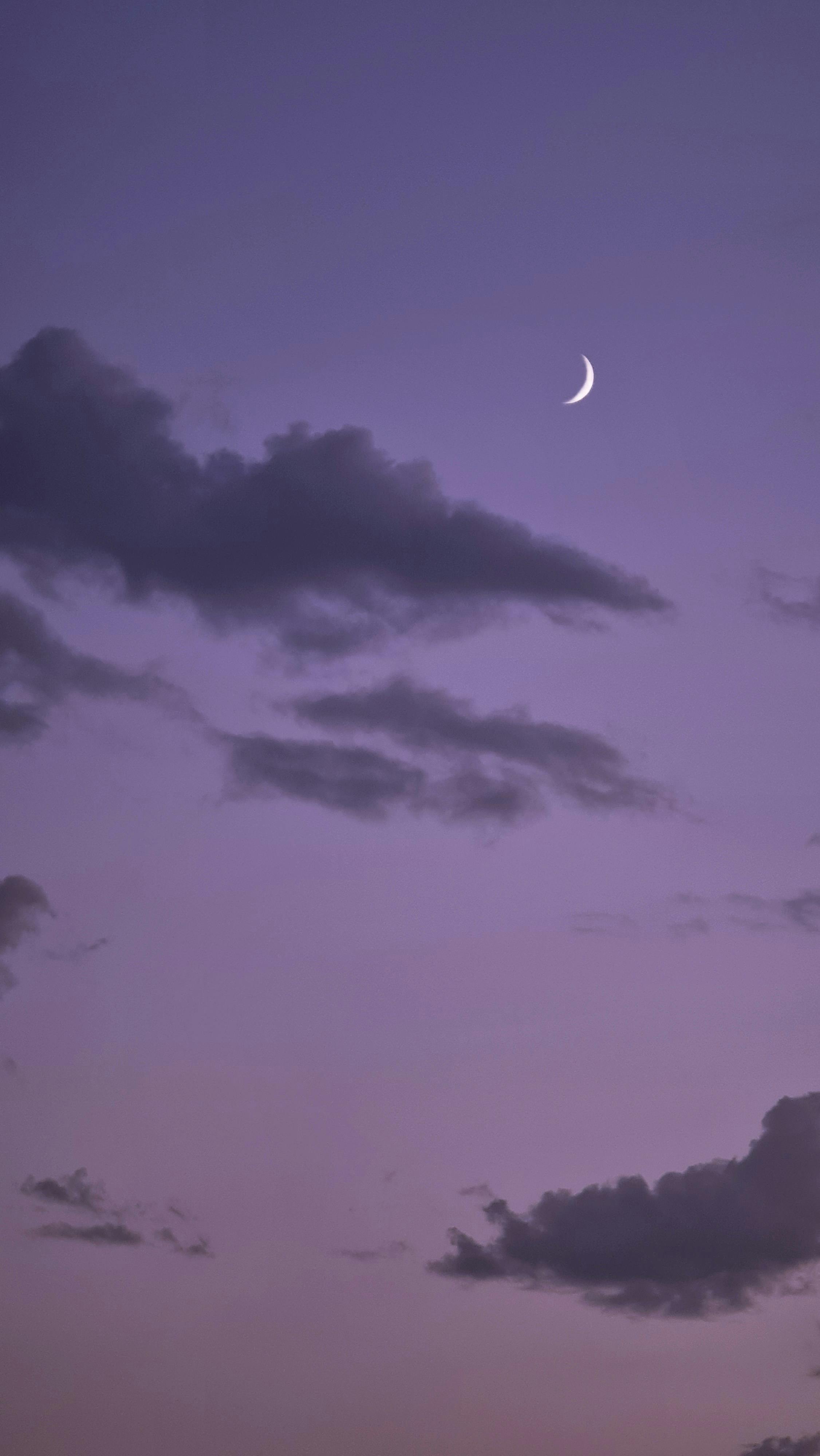 Crescent Moon among Dark Clouds at Dawn