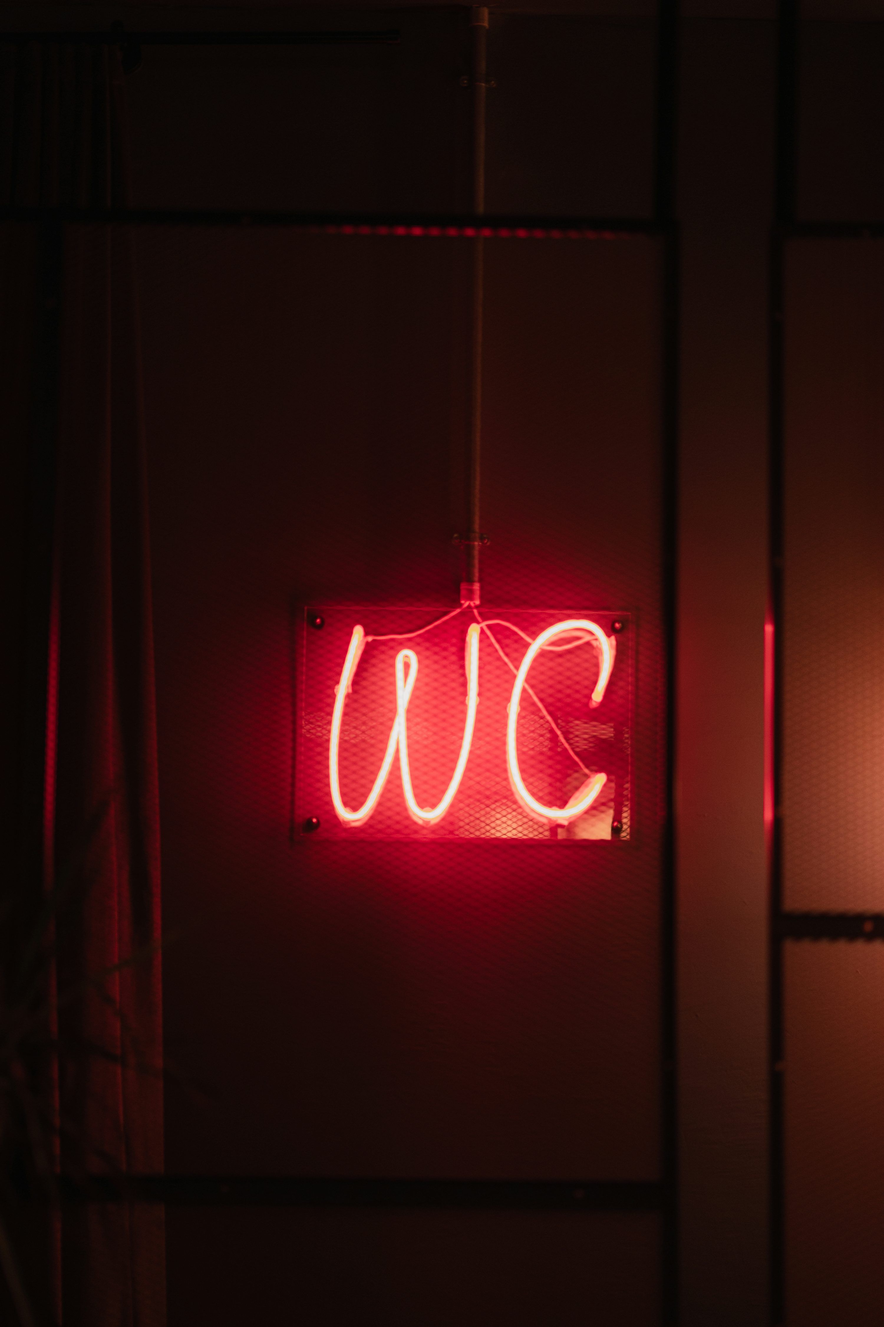 A red neon sign hanging from the side