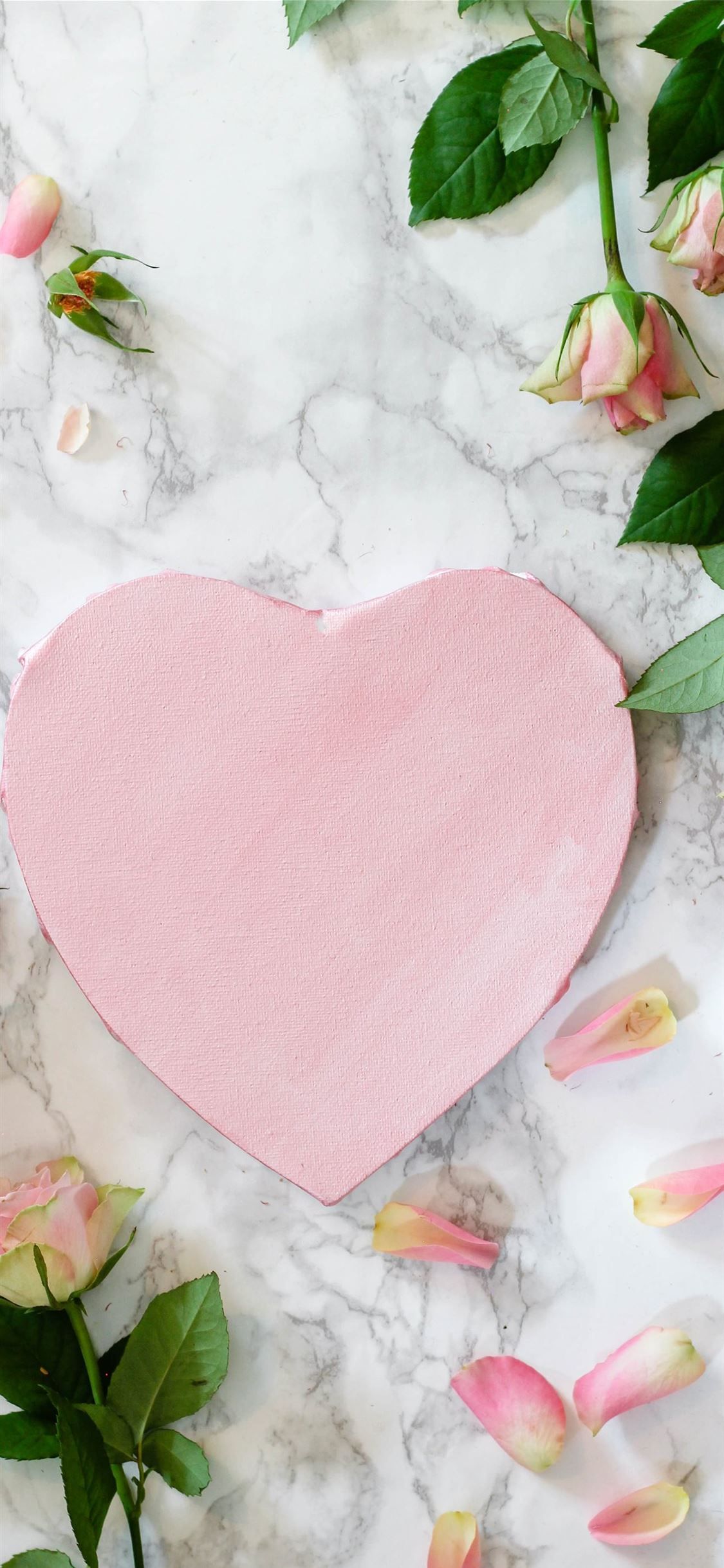 pink heart shaped paper on white