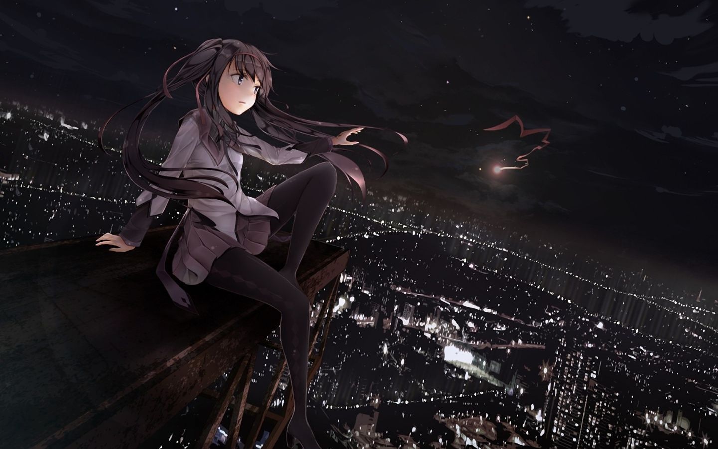 The girl looks at the city at night