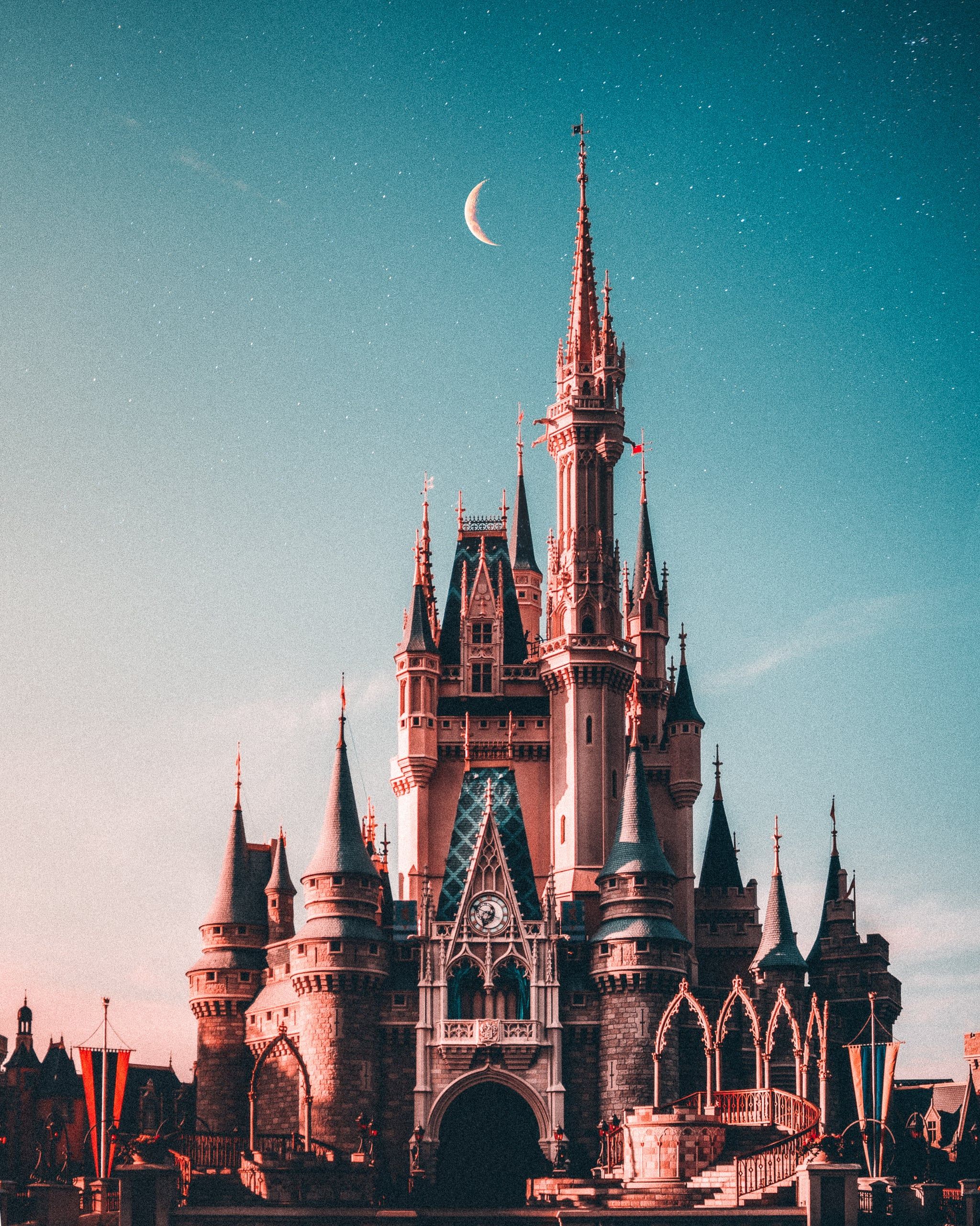 A castle with a crescent moon in the sky. - Disney, Disneyland, castle