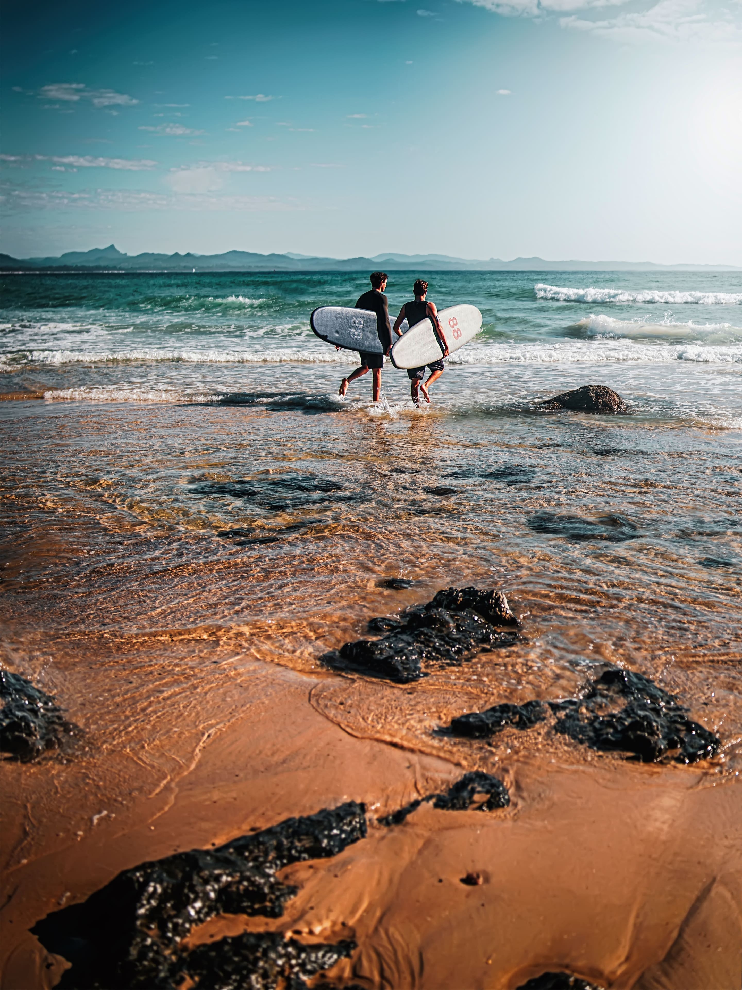 Surfers on the beach wallpaper