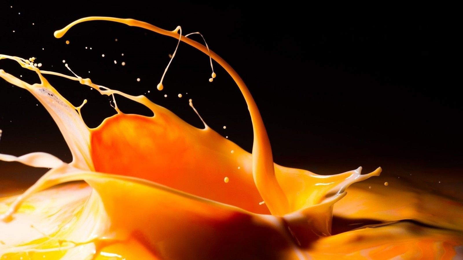 A close up of orange juice spilling out - Dark orange