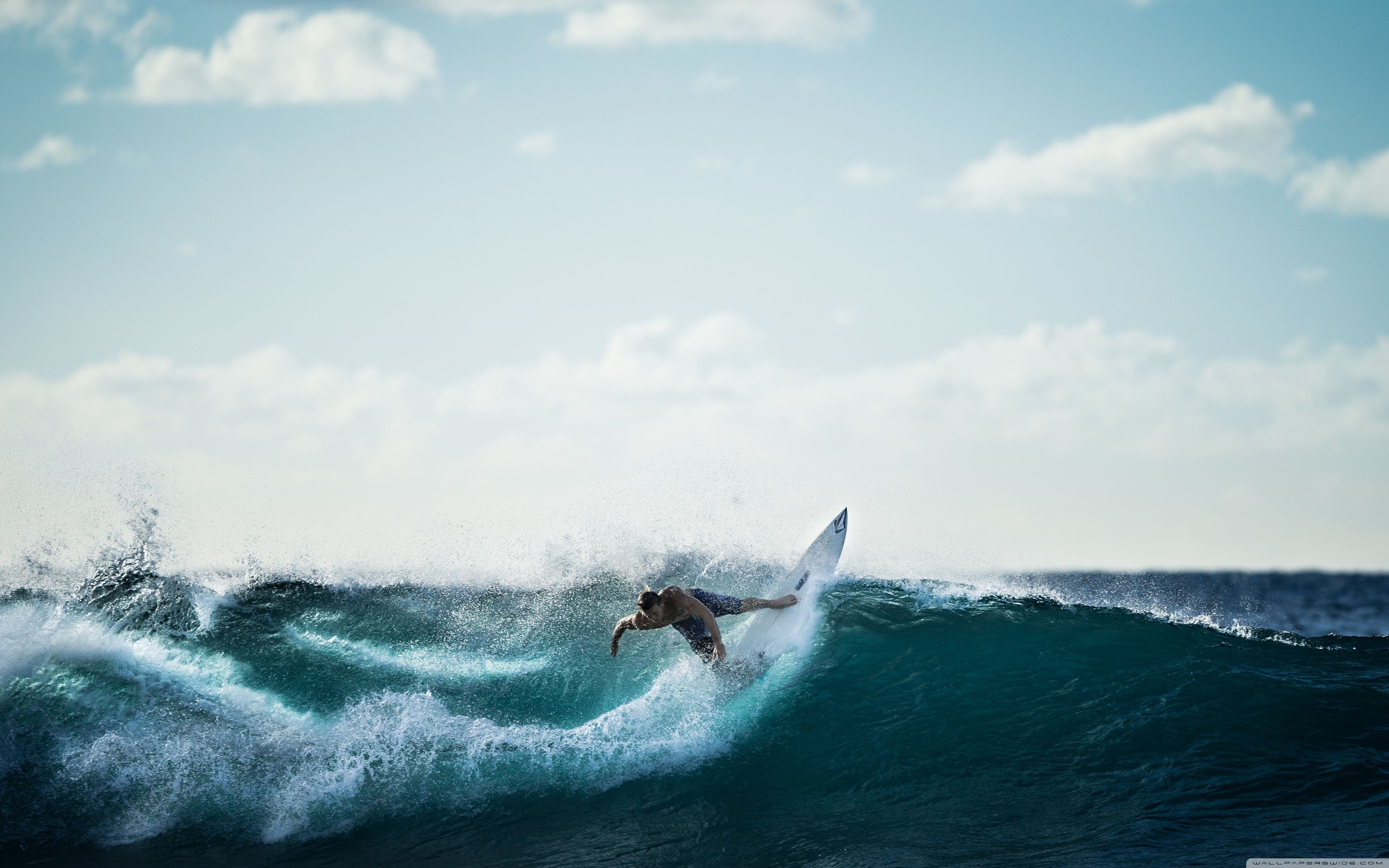 A surfer riding a wave in the ocean - Surf