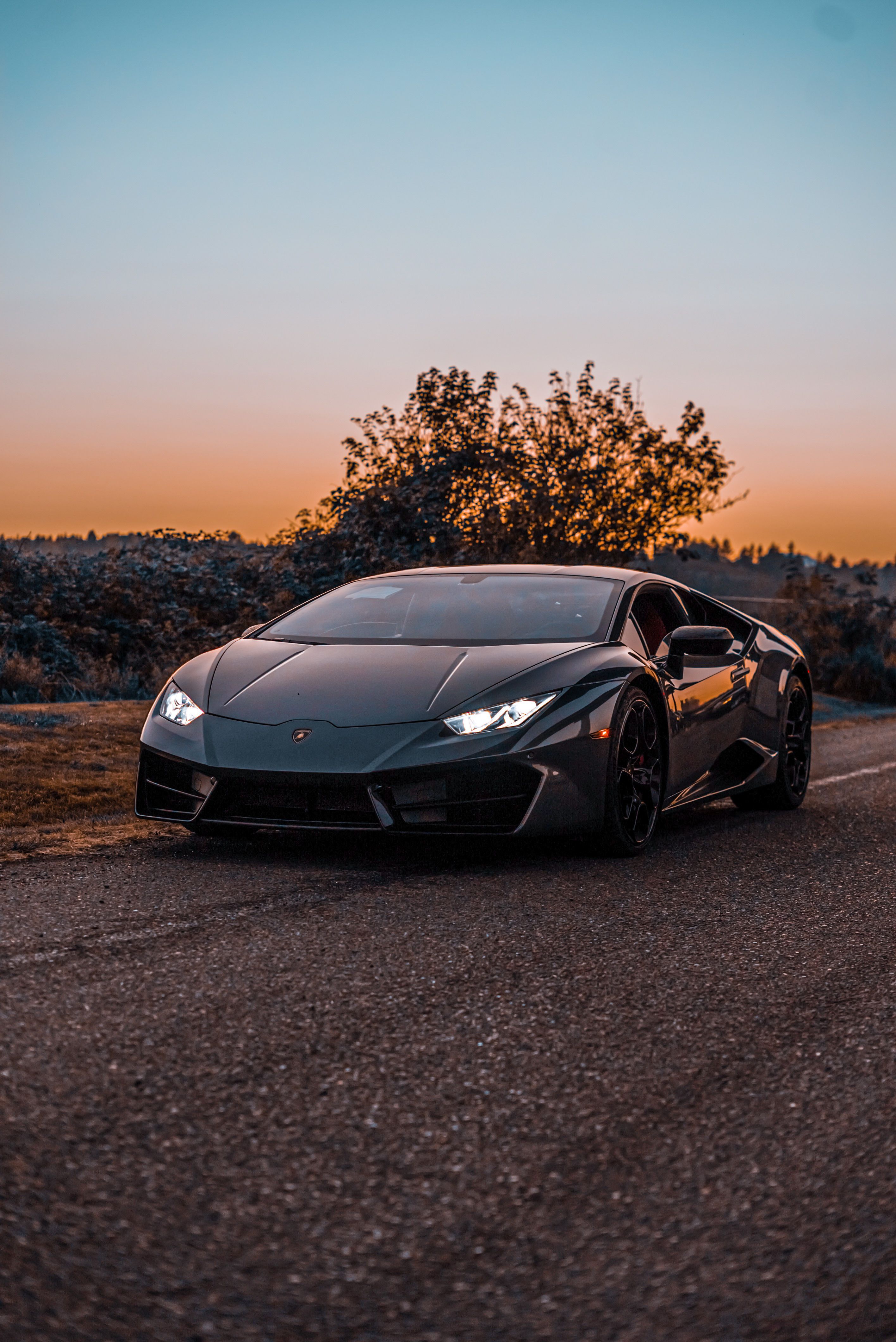 Lamborghini Huracan Parked on Asphalt Road at Sunset · Free
