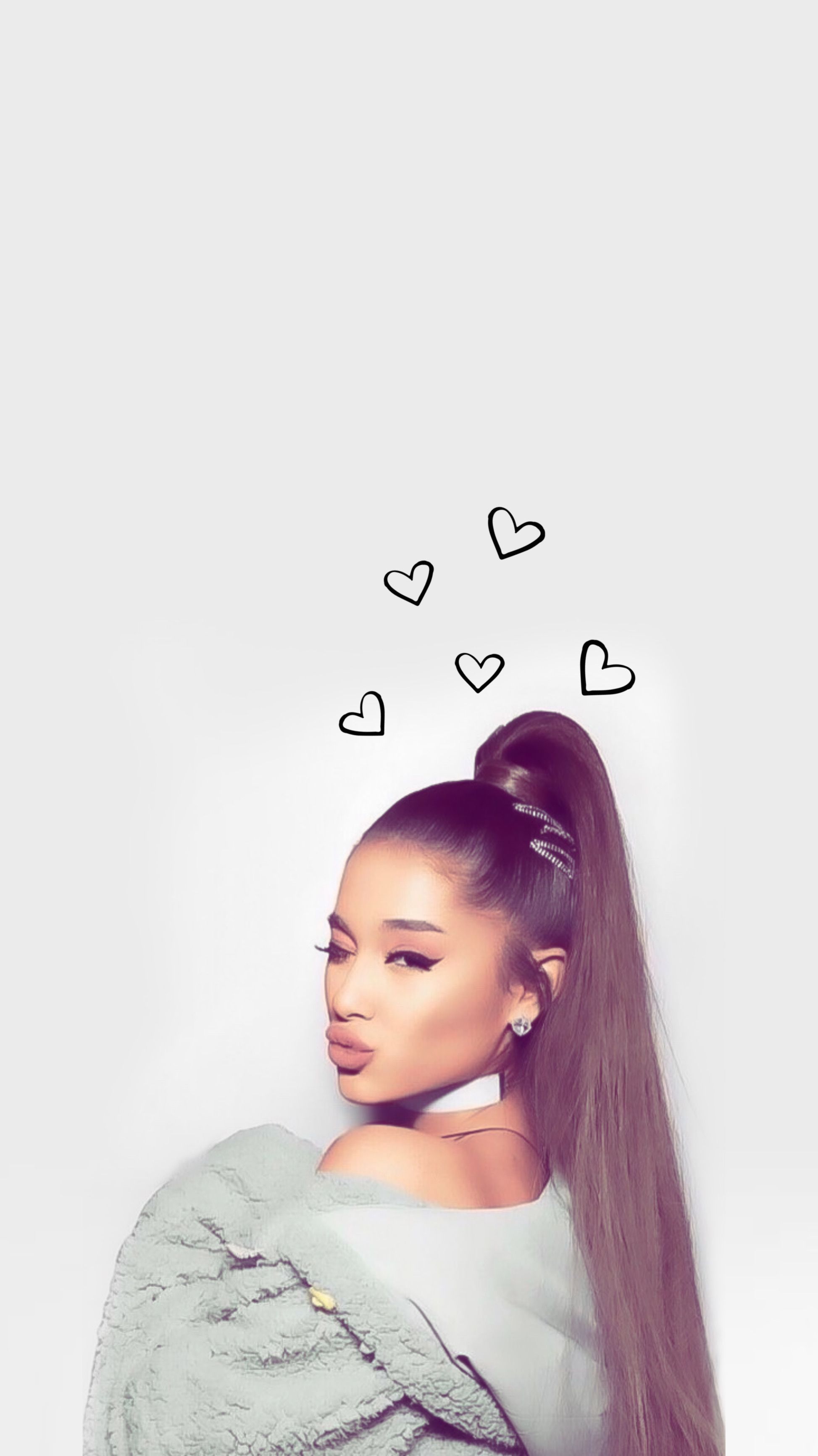 A girl with long hair and hearts above her head - Ariana Grande