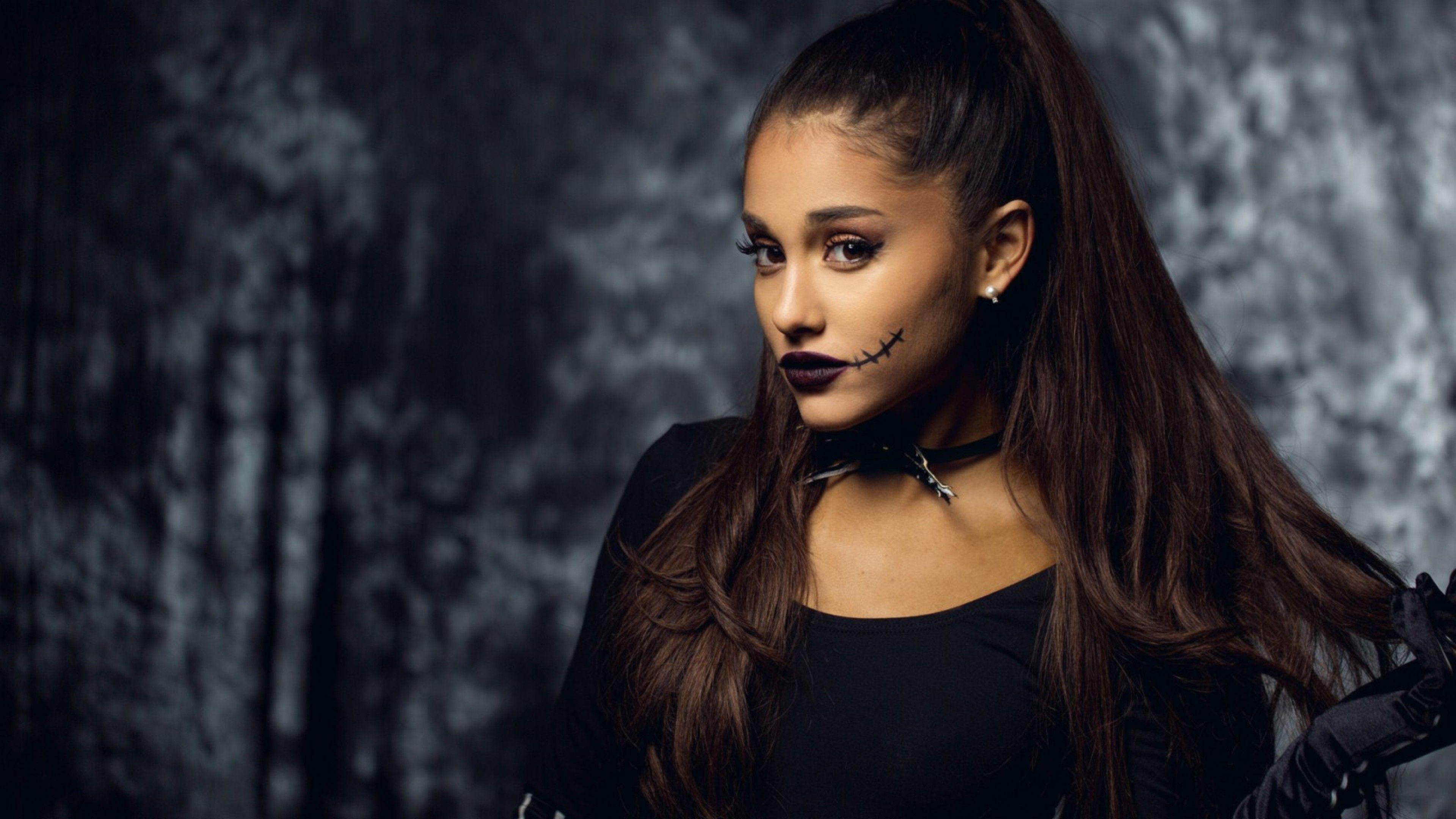 Ariana Grande with a black top and a black choker with a black smiley face on it - Ariana Grande