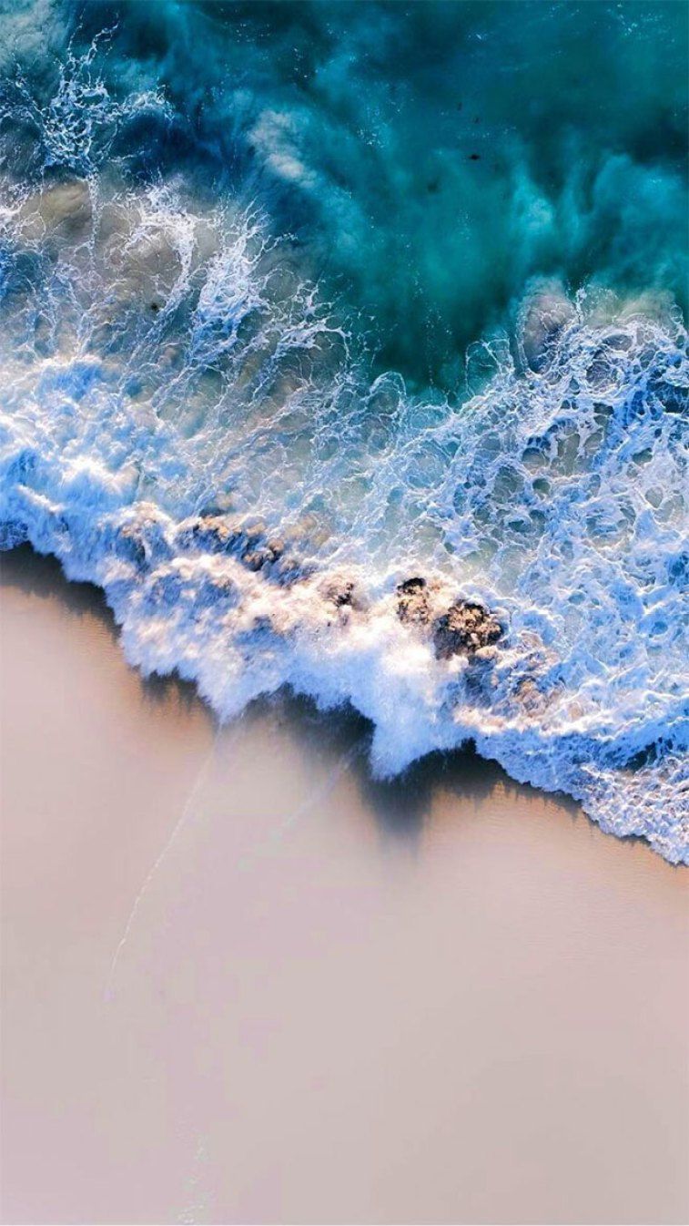 A photo of the ocean with waves crashing on it - Clean