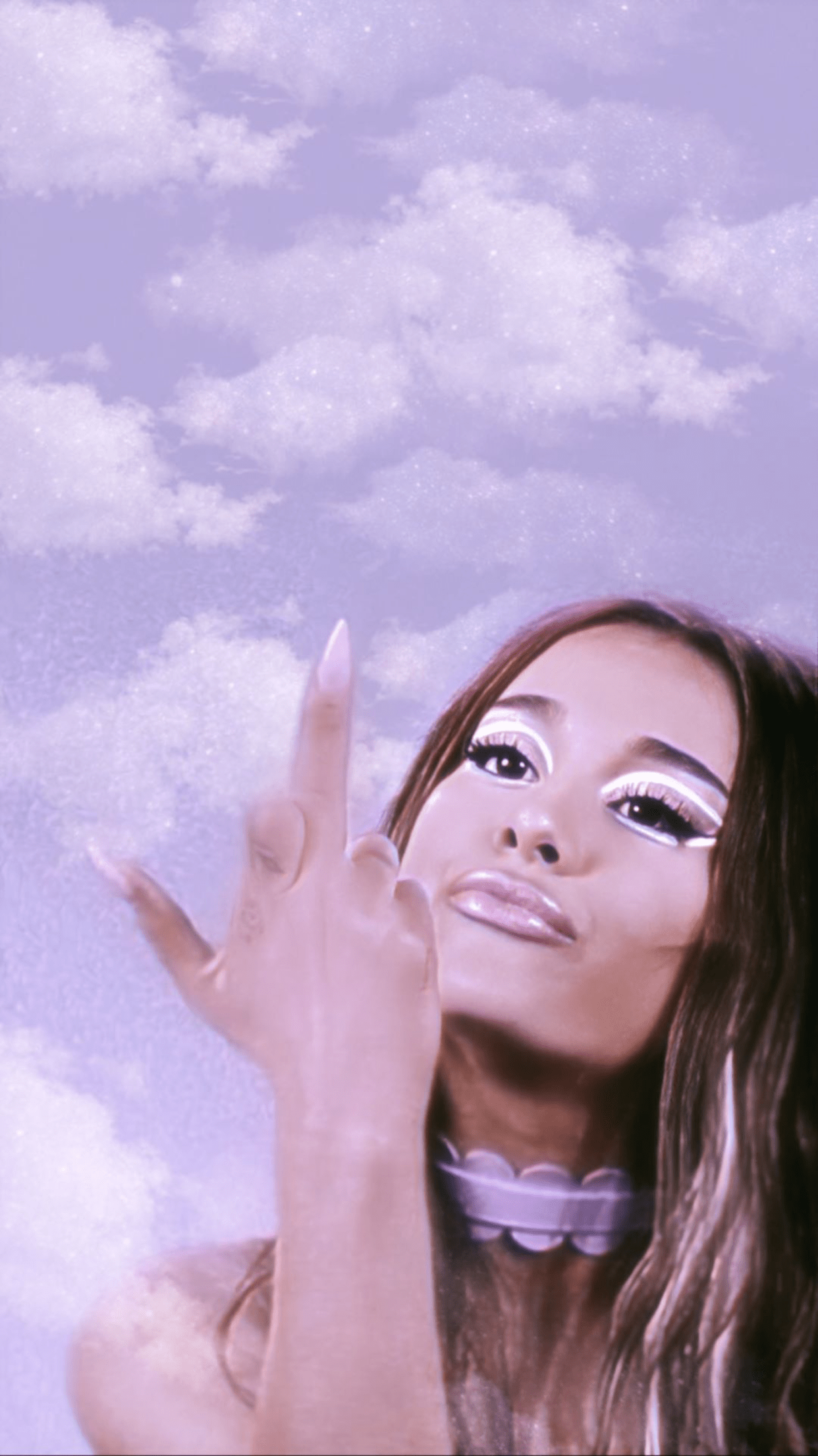 A woman pointing up at the sky - Ariana Grande